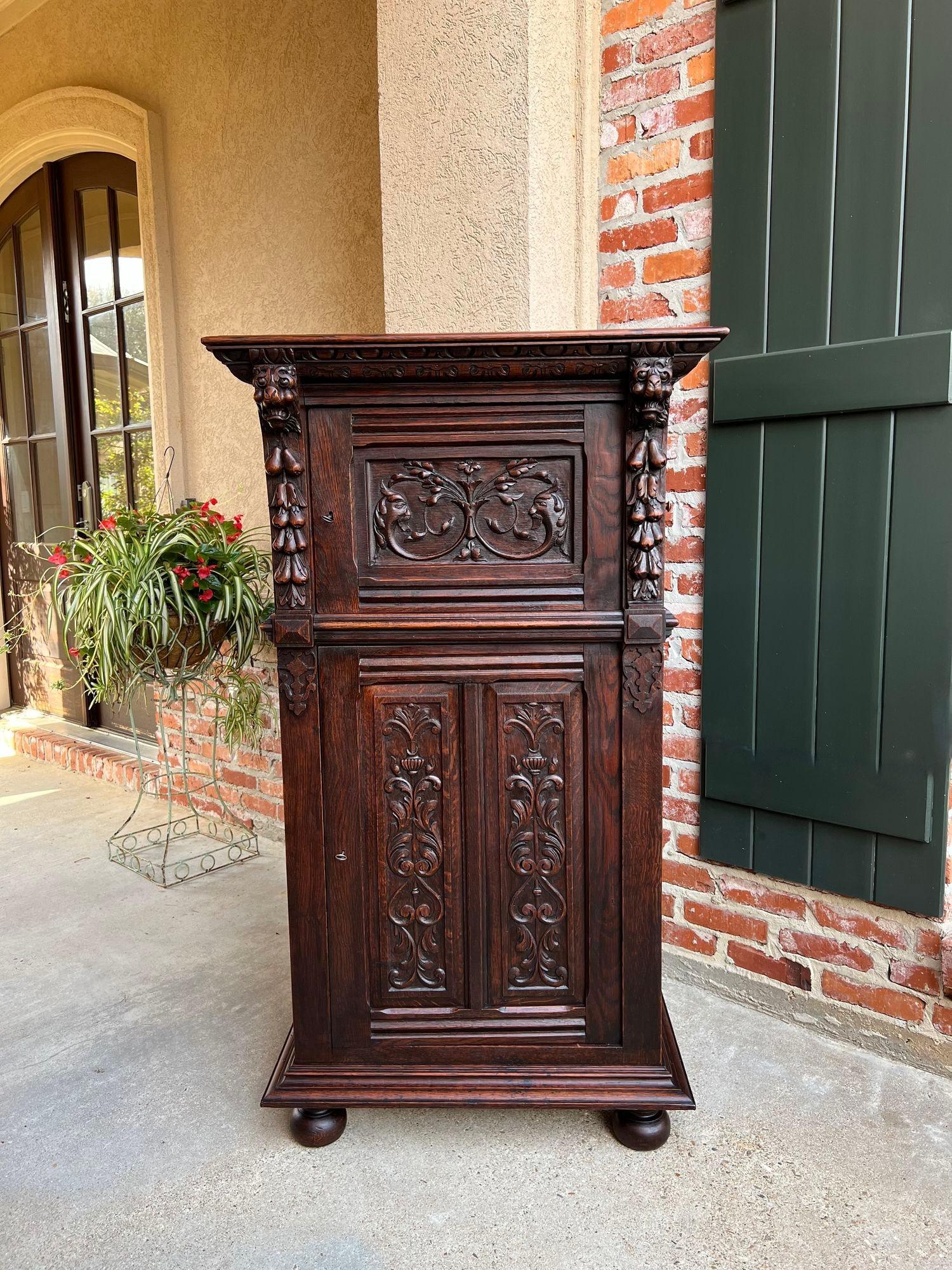 Antique French Cabinet Renaissance carved oak bookcase wine cellarette sideboard.

Directly imported from France, another beautifully hand carved antique cabinet, in a versatile taller size, with unique features! Lavish carvings include columns of