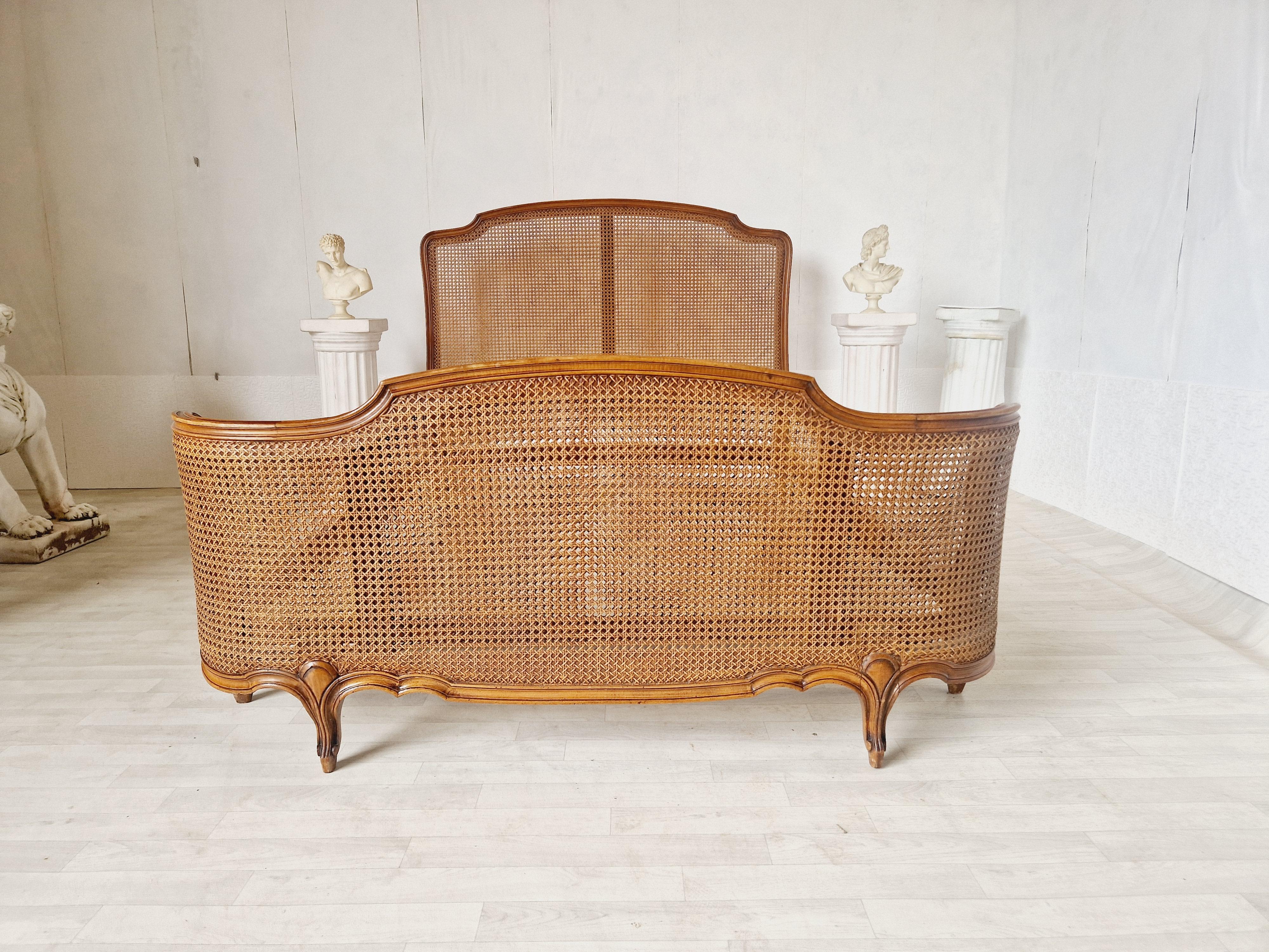 
We are delighted to offer for sale this Cane Corbeille Bed.

This exquisite antique bed will transport you back in time to the elegance of 1920s France. Crafted in the Louis XV style, this Rocaille bed features delicate carvings and a fabulous wood