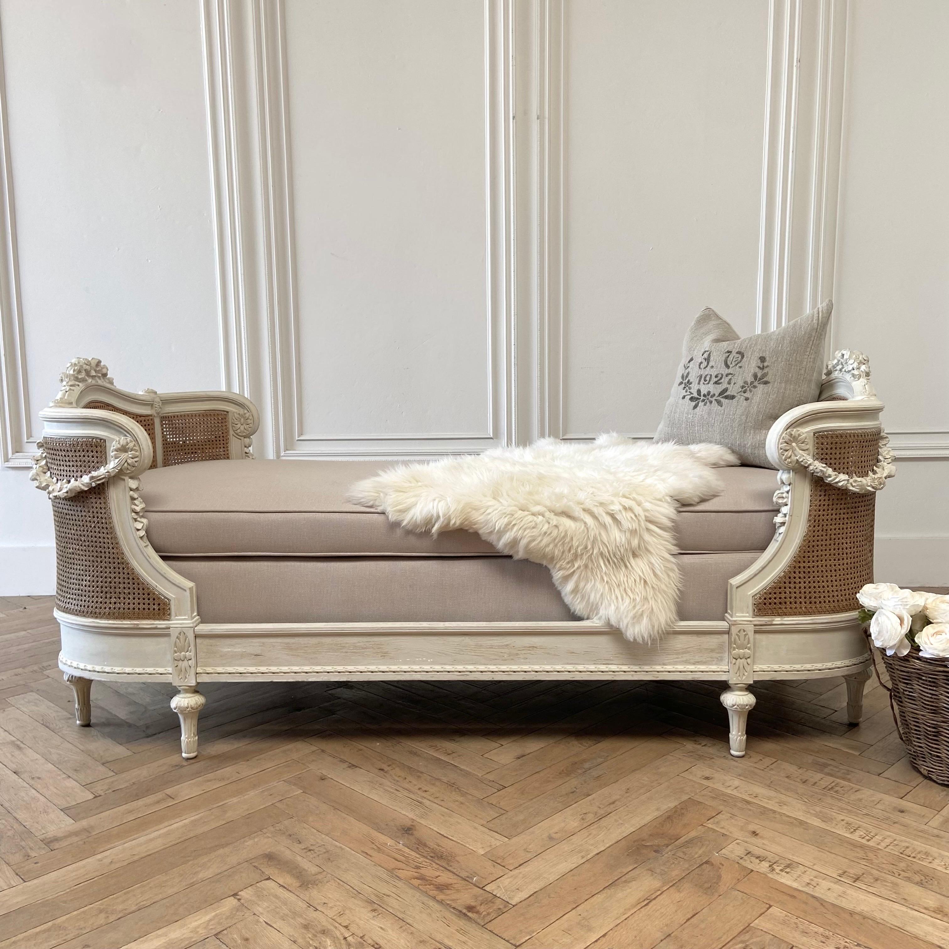 Roses and cane daybed 83”w x 40”d x 36”h
Seat: 23”h
This beautiful antique daybed has the original cane and wood carved rose swags.
Finish is original with touched up paint to some areas, it is an off white, or oyster white color.
Cane is