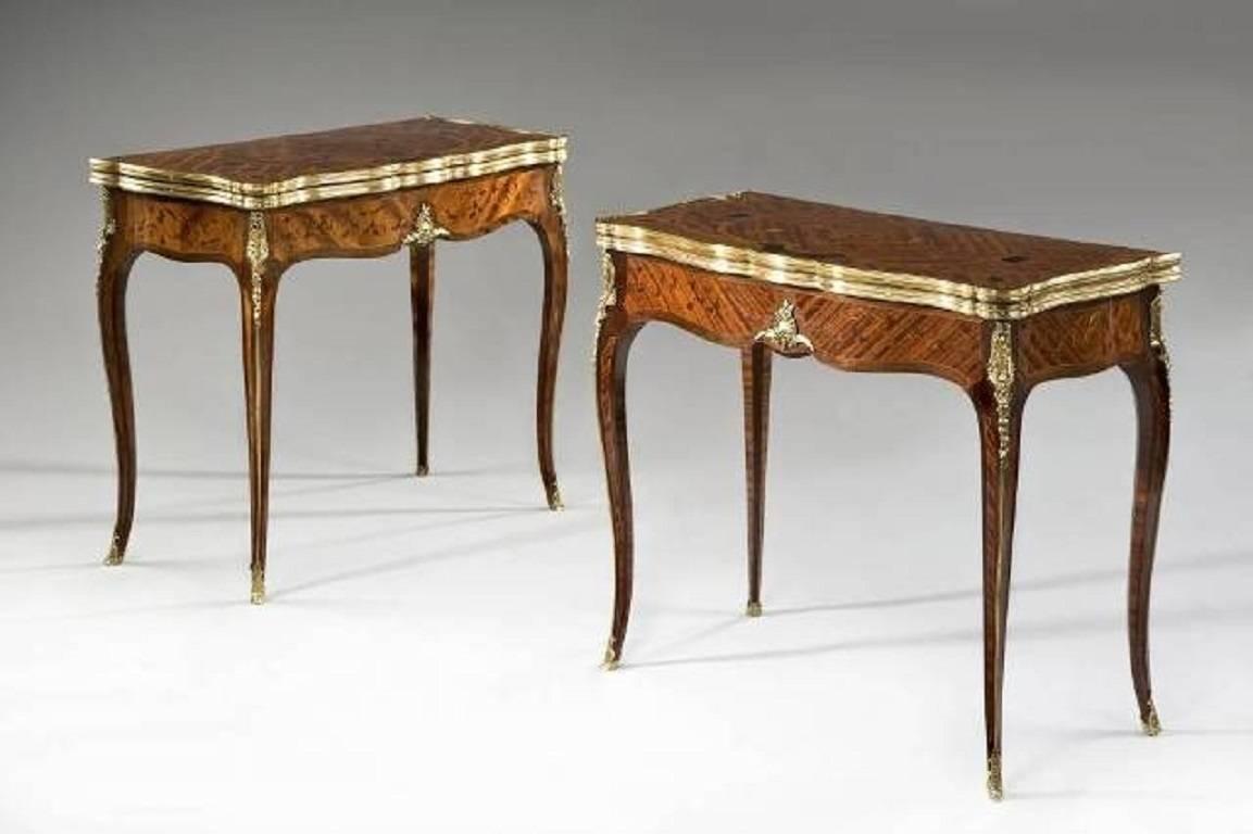 Each of these exceptional kingwood card tables by G Durand has a shared folding top above a serpentine frieze and elegant cabriole legs. The legs are embellished with gilt bronze foliate mounts, edges and sabots. Overall the decoration comprises