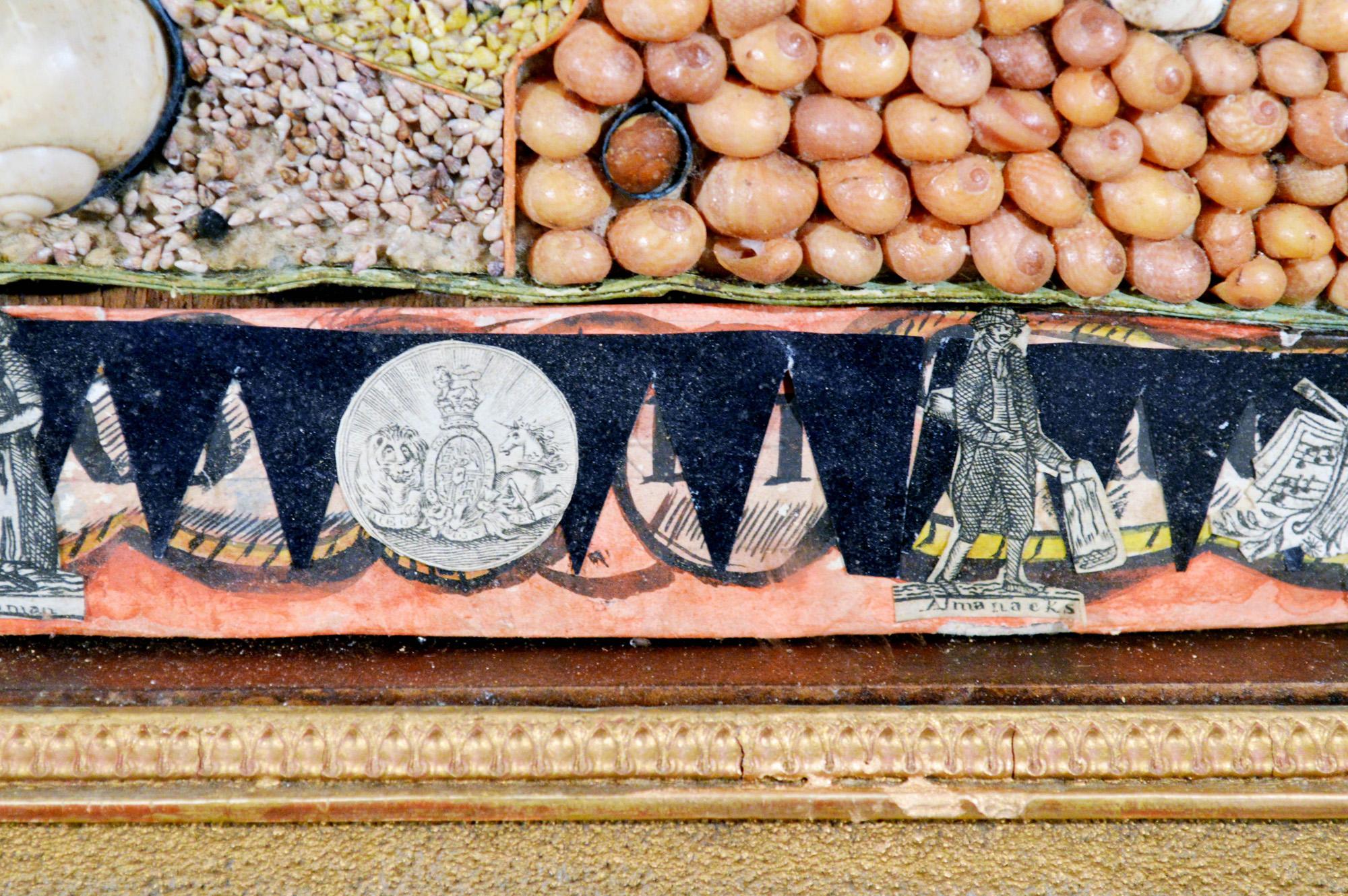 French Caribbean sea shell-work picture,
circa 1820-1840.

The superb early 19th-century rectangular picture with a central reserve depicting naval objects including flags, drums, anchors, medals, and cannon and created with tiny shell seeds. The