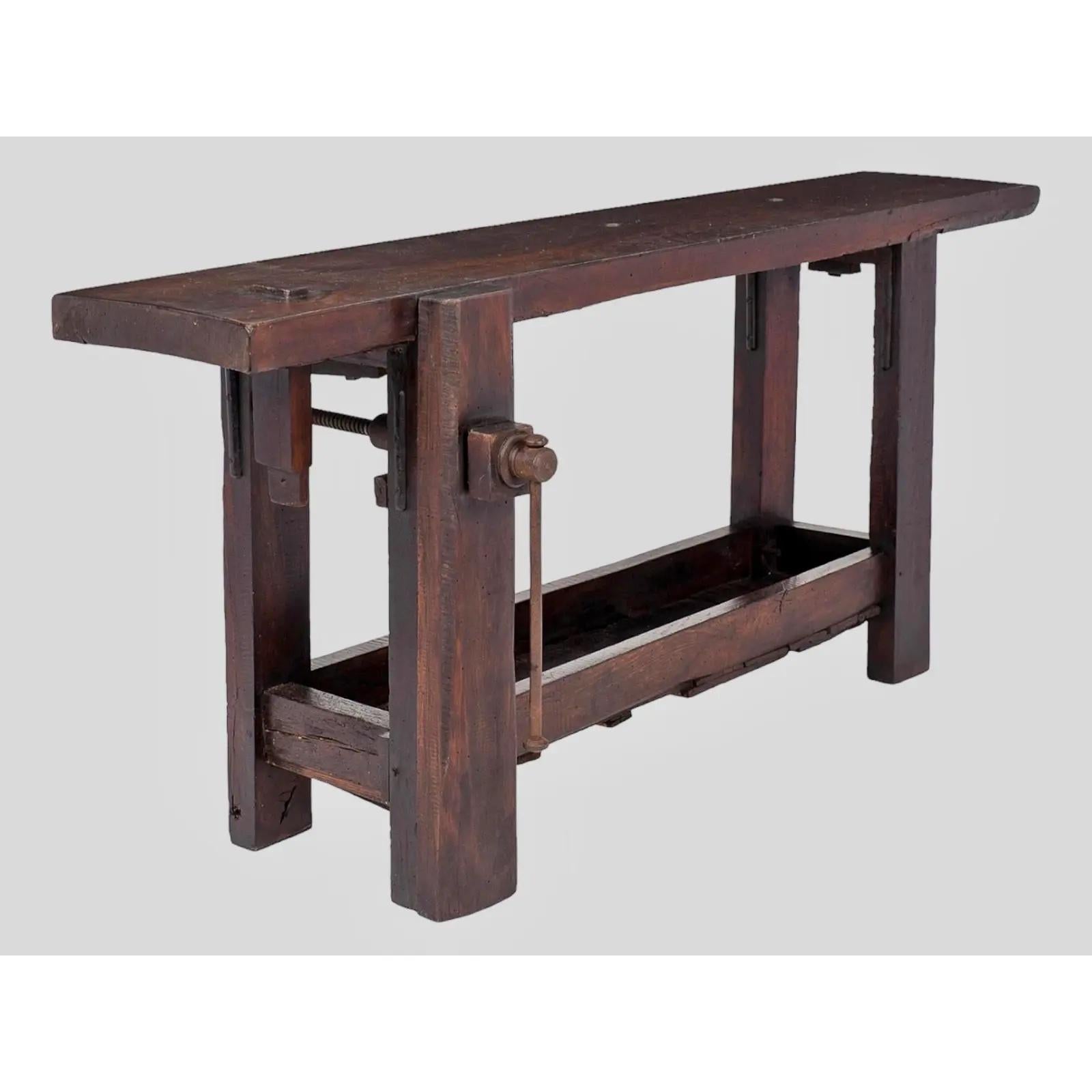This Antique French Workbench, Circa 1880, is a beautiful, old carpenter's bench.  It has a rich, dark coffee stain with a nice patina.  It has a rustic charm that could be mixed with both modern and period pieces.  It has a tabletop measuring 21