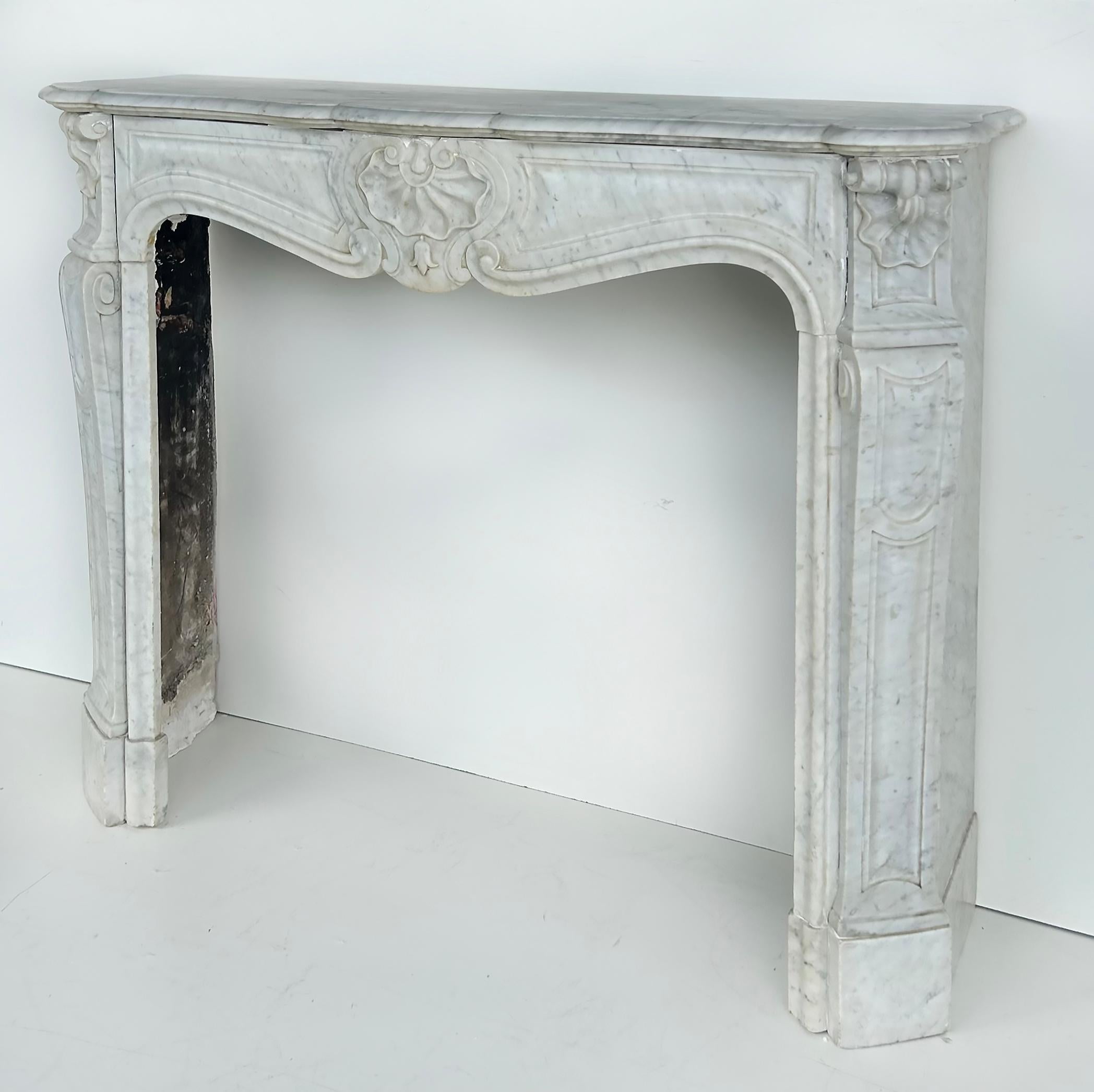 Antique French Carrara Marble Louis XV Style Fireplace Mantel 

Offered for sale is an antique French Louis XV style white Carrara carved marble fireplace mantel which is a fresh estate find from an important Key Biscayne, Florida estate.  This