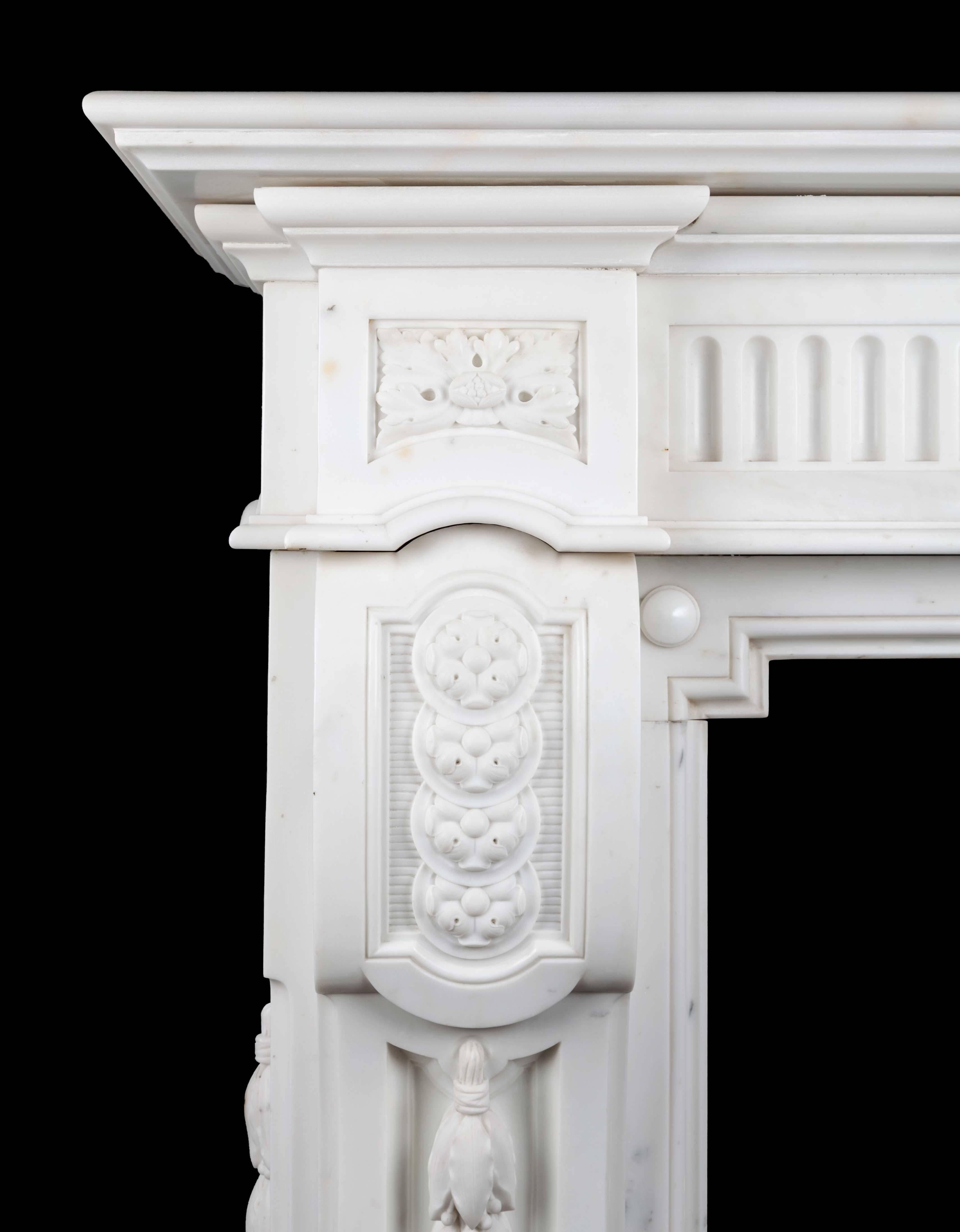 Antique French statuary Carrara marble mantelpiece of large scale and great quality. This magnificent Napoleon III style mantelpiece is beautifully carved in the purest of white statuary marble.
The fluted frieze with a highly carved centre tablet