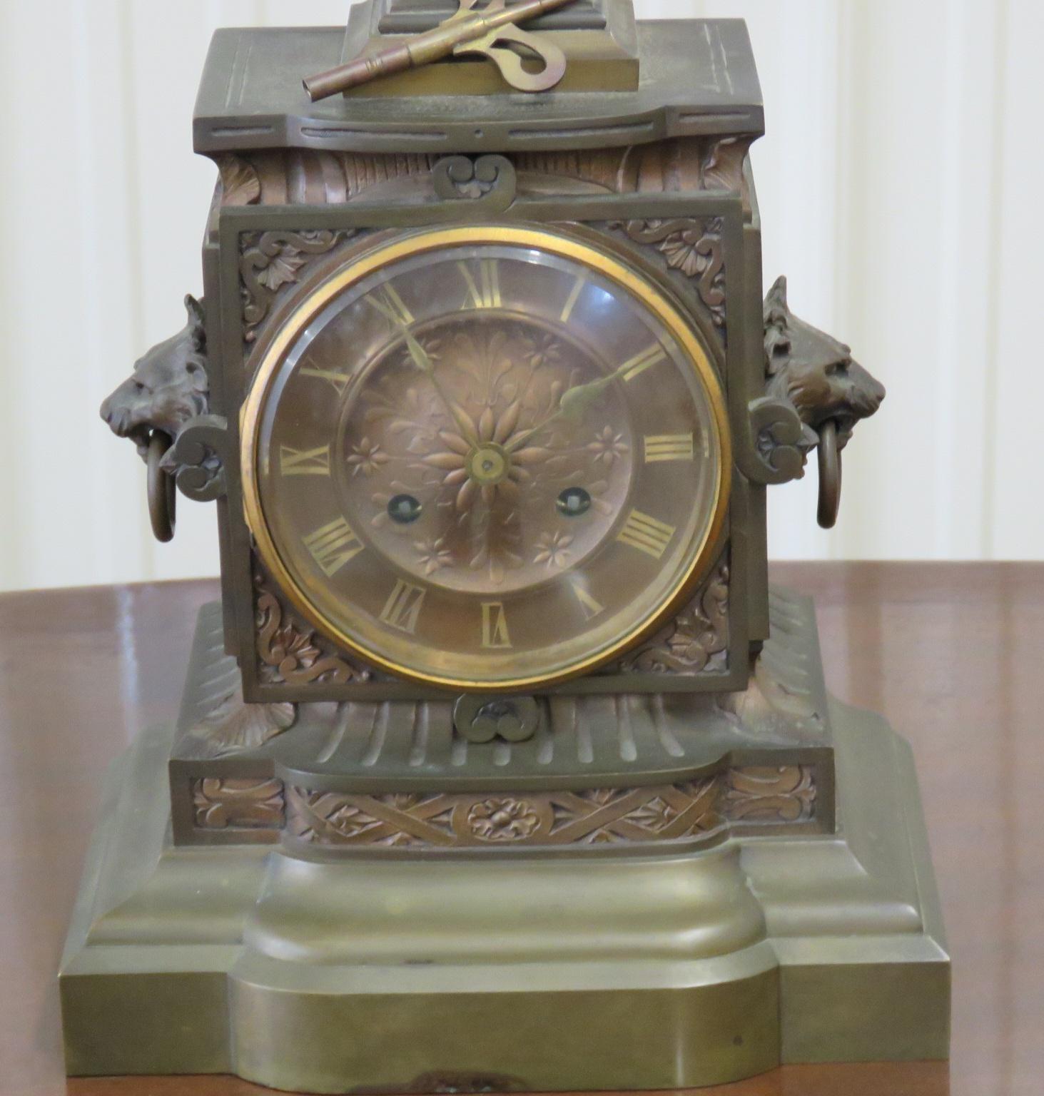 Antique Bronze French Carrier Belleuse clock with a female bust and lions heads on the sides.