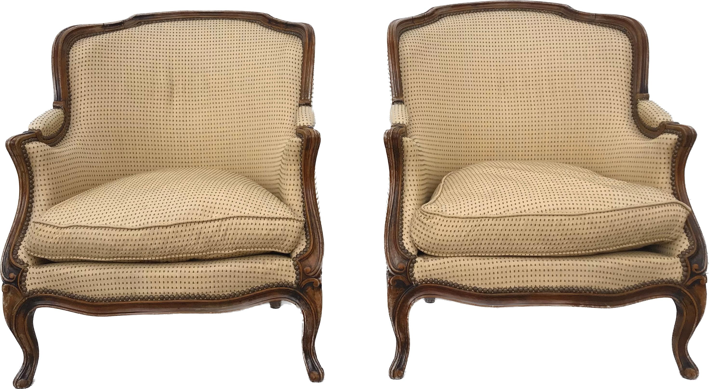 Elegant French bergeres with carved walnut frames. Crisp carved frames. Solid sturdy pair of Bergere Chairs. These are in very good condition with minimal wear to the frames or the upholstery. 