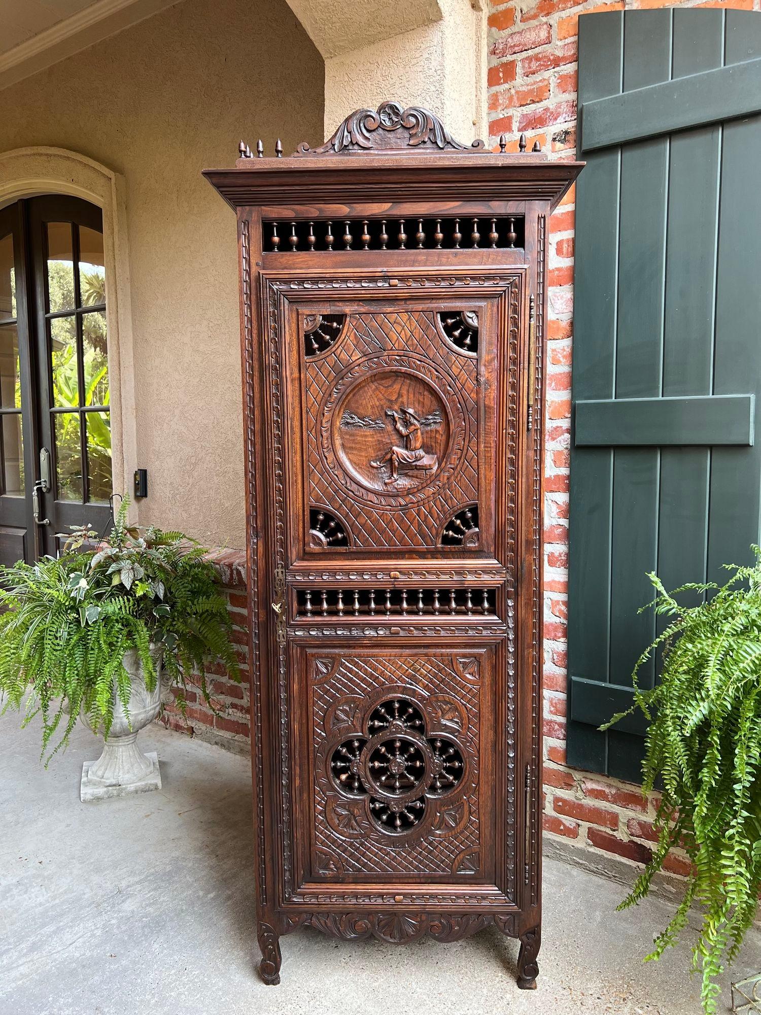 Antique French Carved Bonnetiere Armoire Cabinet Brittany Breton Ship Spindle.

Direct from France, a lovely antique French armoire or “bonnetiere” cabinet, with gorgeous hand carvings throughout.  The slender, smaller size makes a “bonnetiere”