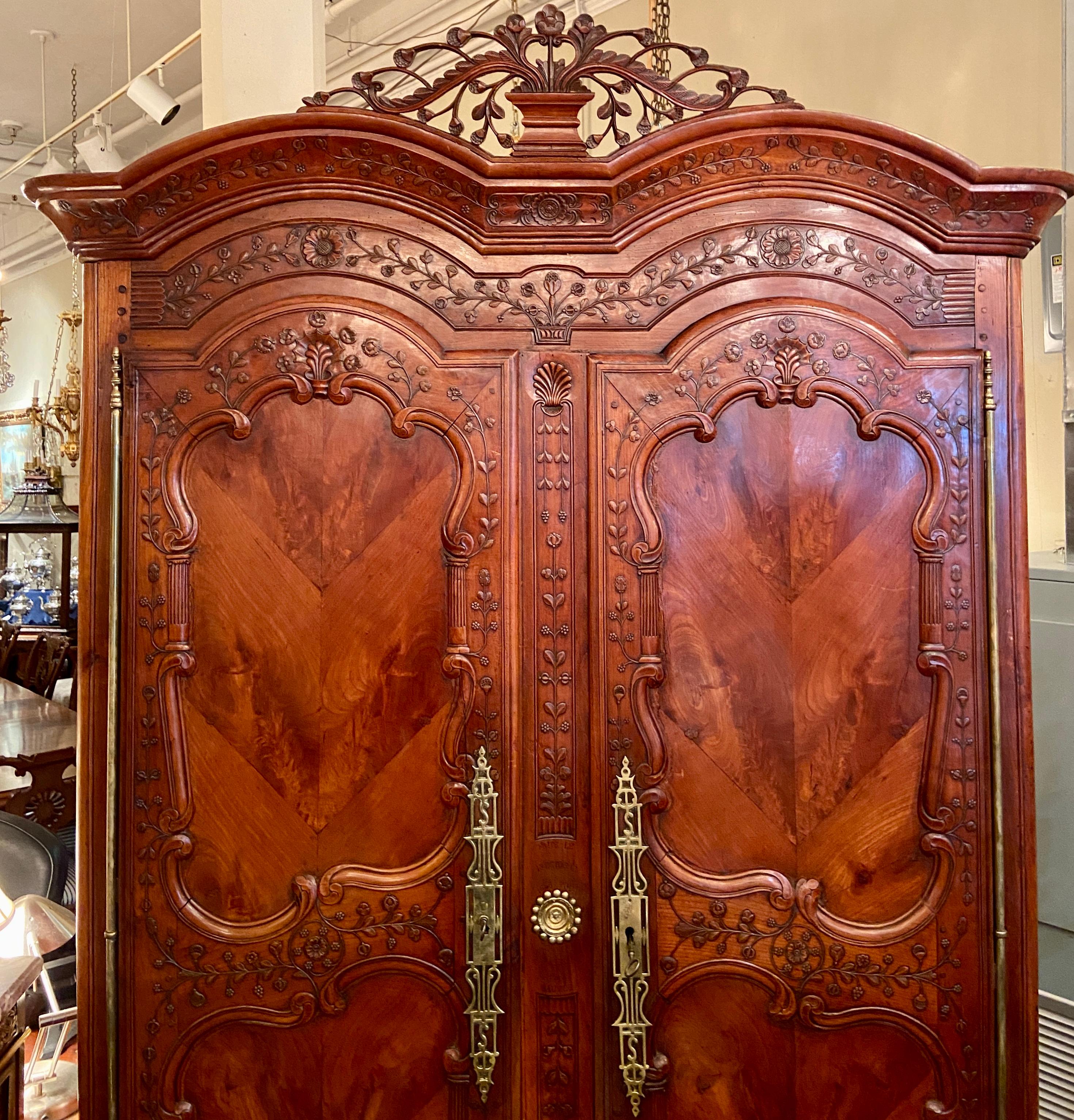 Antique French carved Cherry wood Armoire de Breton, from Rennes in the Brittany Region of France, Dated October 13th, 1846. Intricate carving and beautiful old hardware.