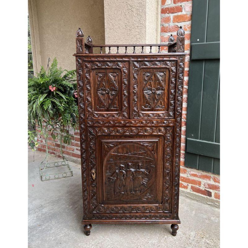Antique French Carved Chestnut cabinet Bonnetiere Armoire Breton Brittany.

Direct from France, a highly carved “Brittany” cabinet, in a one-piece, slender size, versatile for placement throughout the home.
The style and design are true to the