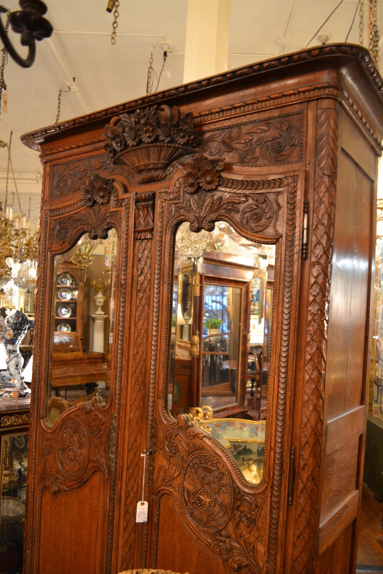 Antique French Carved Elm Armoire with Beveled MIrror Doors For Sale at