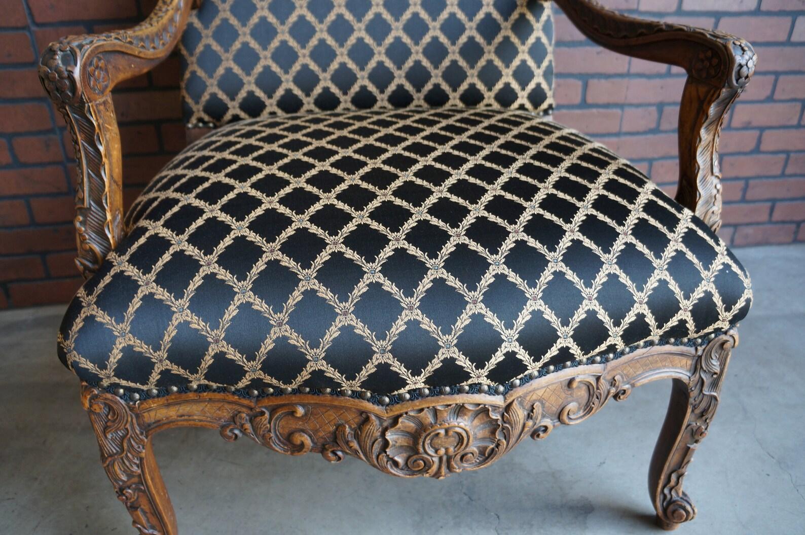Incredible hand carved wood frame upholstered arm chair. The perfect compliment to any European Inspired decor. Upholstered in a lovely diamond pattern with solid black back, detailed with gimp trim and nailhead, a beautiful designer touch.