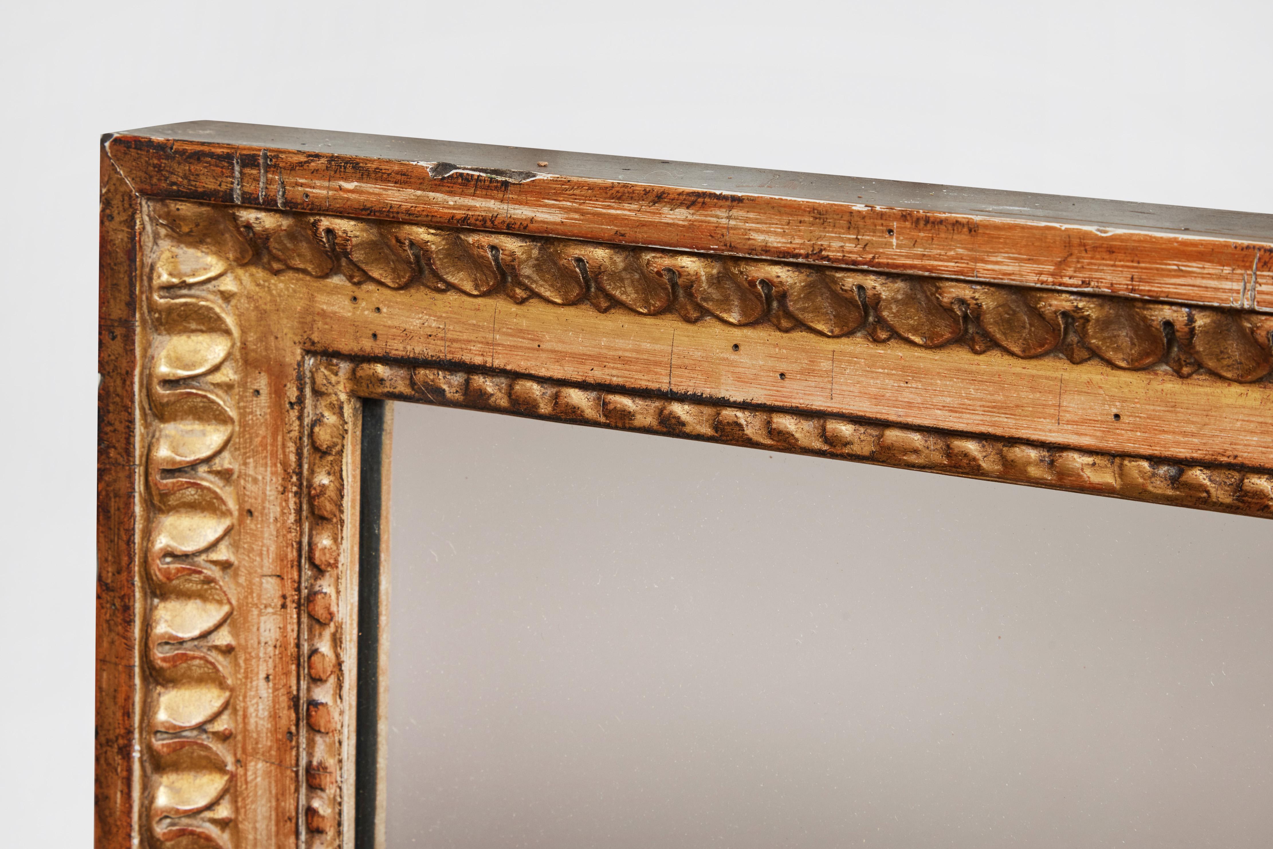 Antique French hand carved giltwood wall mirror from Pierre Deux.