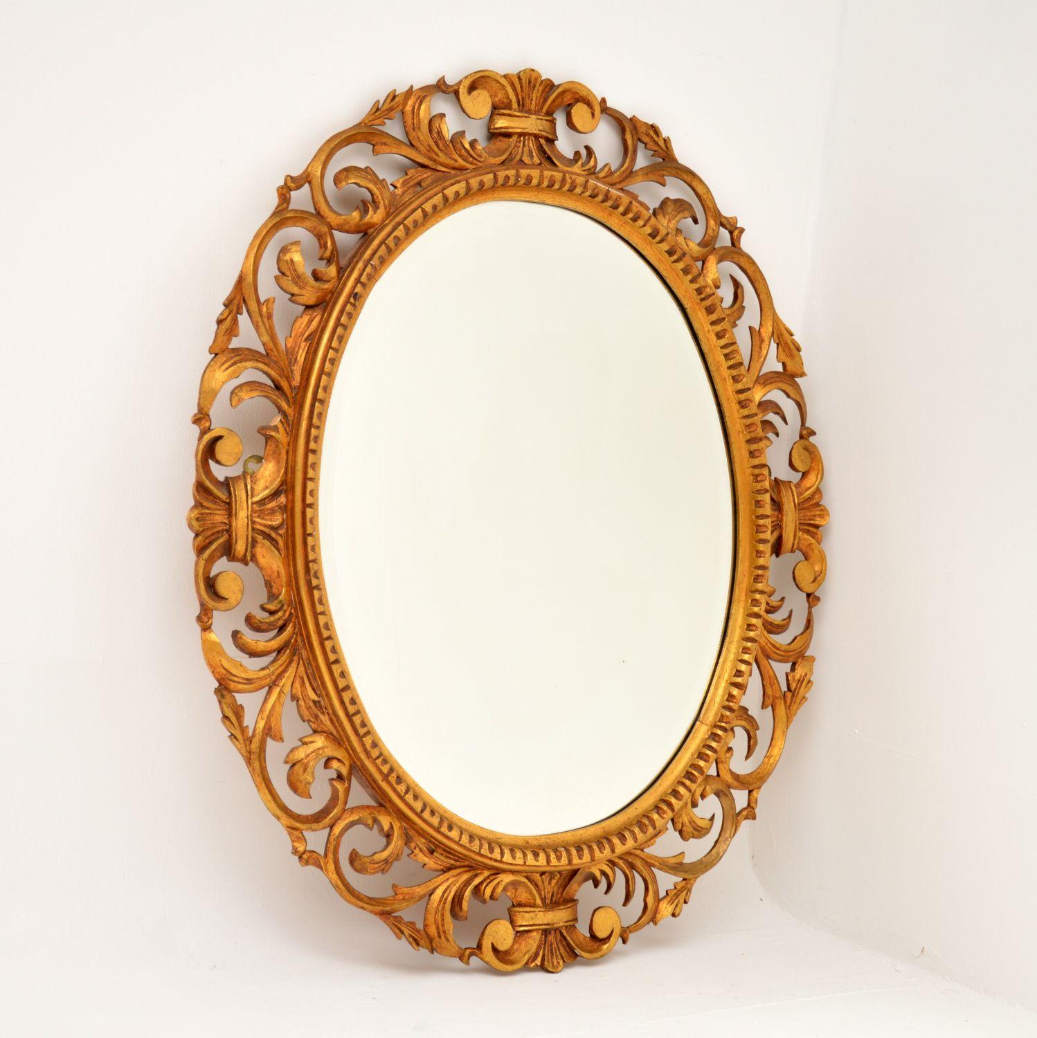 A stunning antique French gilt wood mirror in the Rococo style. This was made in France, it dates from around the 1930’s.

The quality is excellent, this has beautiful and intricate carving all over the oval frame. The gilt has a lovely finish and