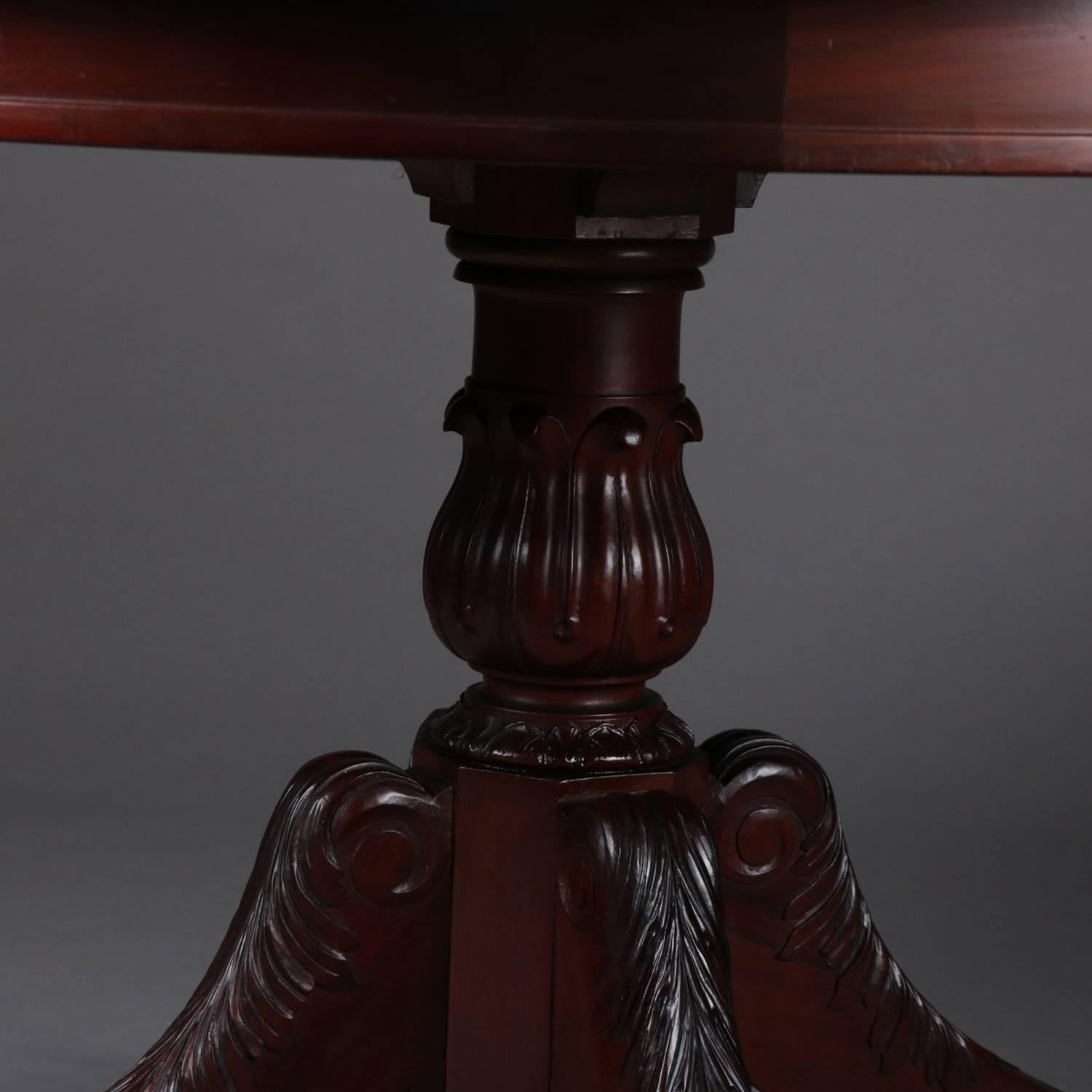 Antique French carved mahogany centre table features rope twist border top supported by urn form pedestal raised on four acanthus carved legs terminating in paw feet surrounding central drop finial, protective glass top, circa 1900

Measures: