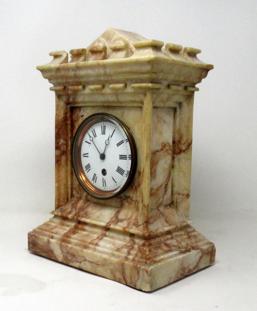 An exceptional well figured carved marble mantle clock of French origin, second half of the 19th century.

The stunning example of architectural outline with an arched roof within a surrounding crenellation modelled to resemble an ancient