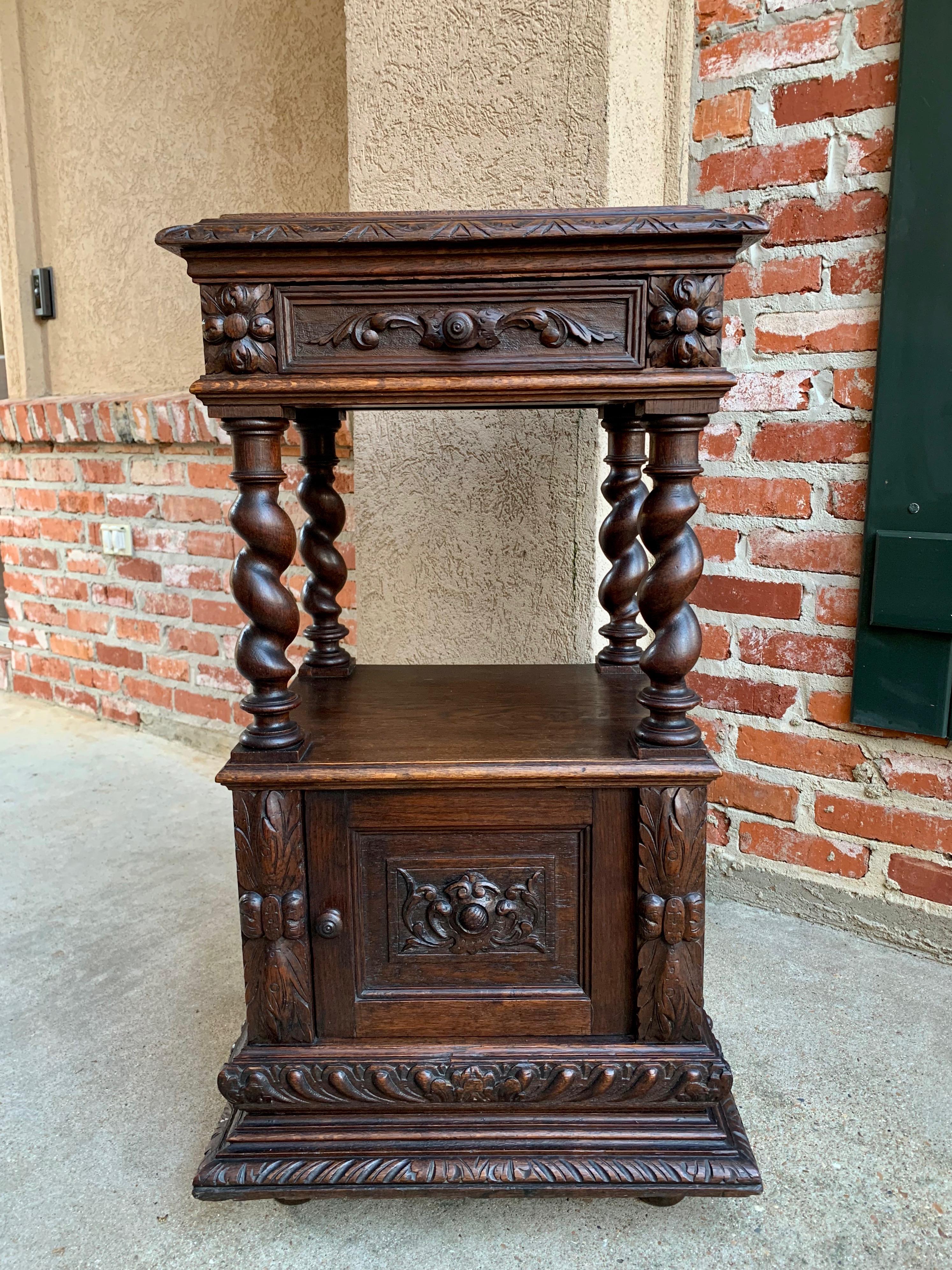 Direct from France, a lovely French carved oak tall occasional table or pedestal stand!
~ Barley twist posts on all four sides with both upper and lower carved beveled edges. Dimensional carvings on the recessed door and drawer panels as well as