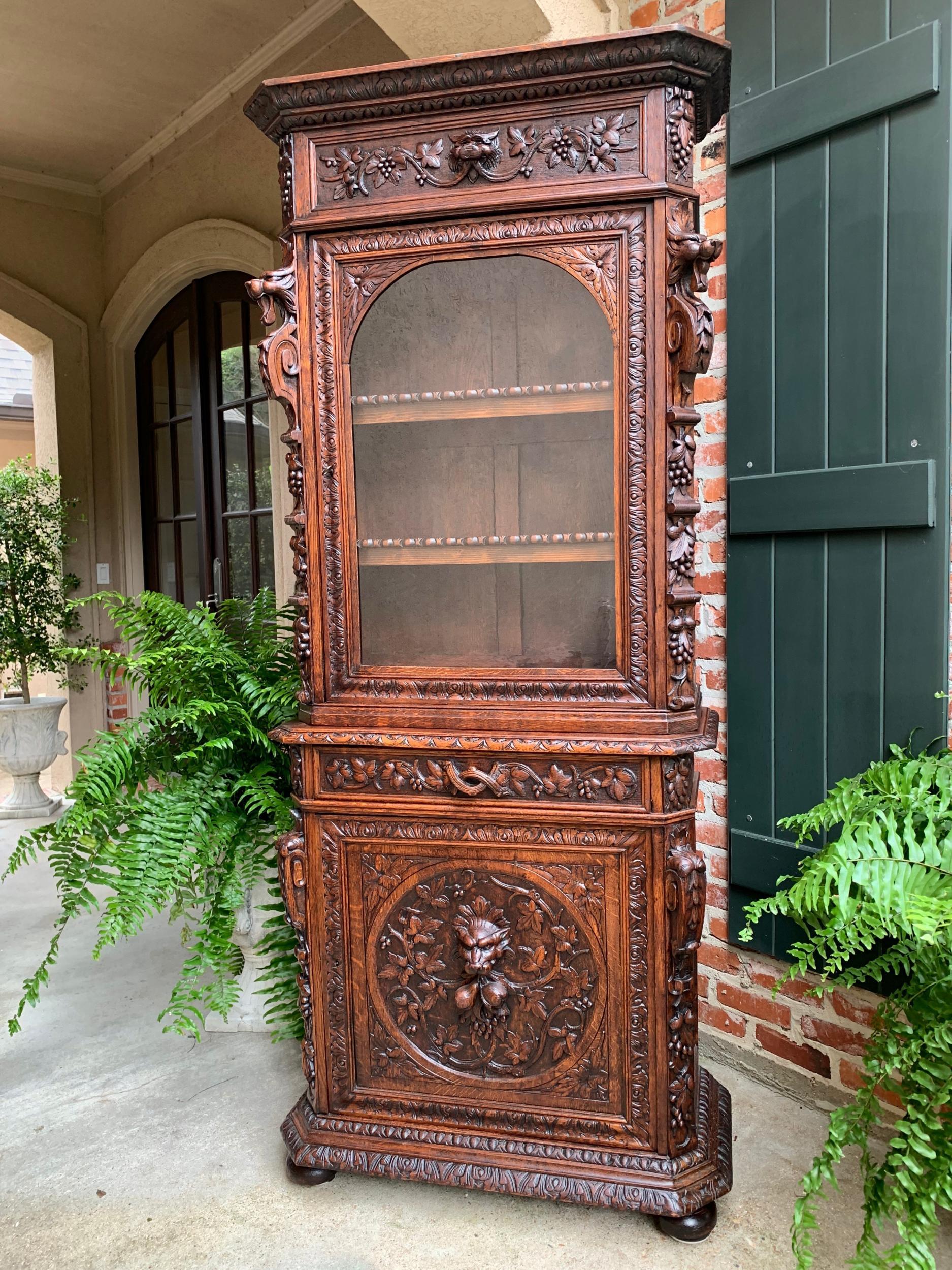 Antique French Carved Oak Cabinet Bookcase Renaissance Lion Black Forest Vitrine

~Direct from France~
~Stunning, unique hand carved details on this 19th century French bookcase, in a 7 ft. tall, yet slender profile~
~High carved upper crown,