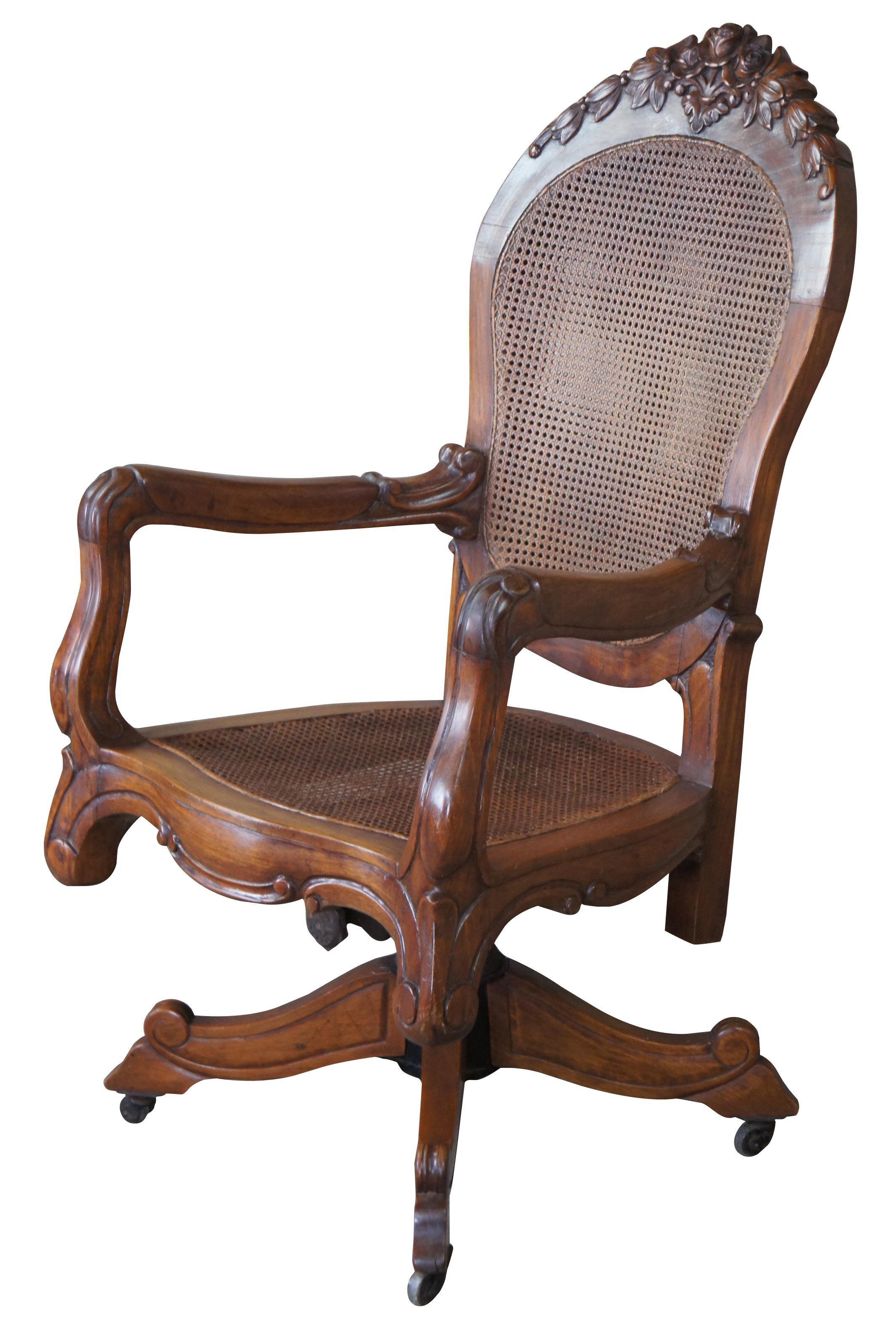 Antique French executive office armchair, circa 1890s. Made of oak featuring carved floral accents, caned seat and double caned back and rolling swivel base. Marked Gilson Canada on industrial base. Sometime before 1900 the company began making