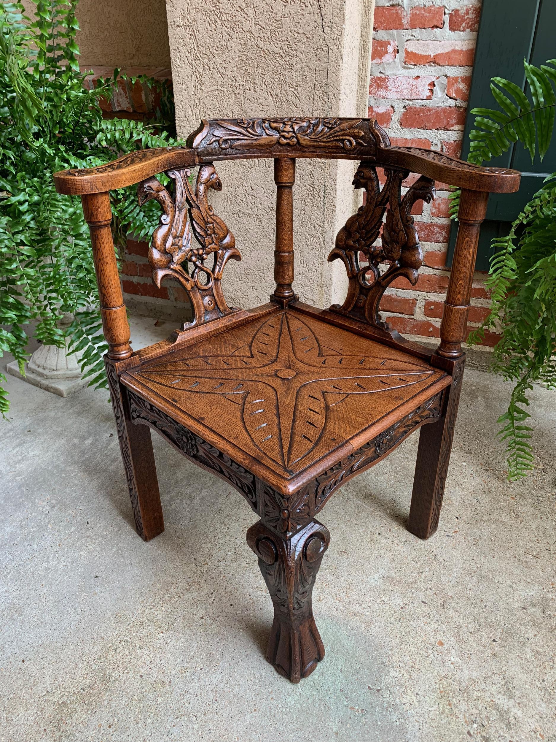 Antique French carved oak corner arm chair Renaissance Louis XIV style

~Direct from France~
~Beautiful carving throughout this versatile antique French corner chair~
~Carved mask to the chair back and carved tops on the serpentine arms~
~Large,