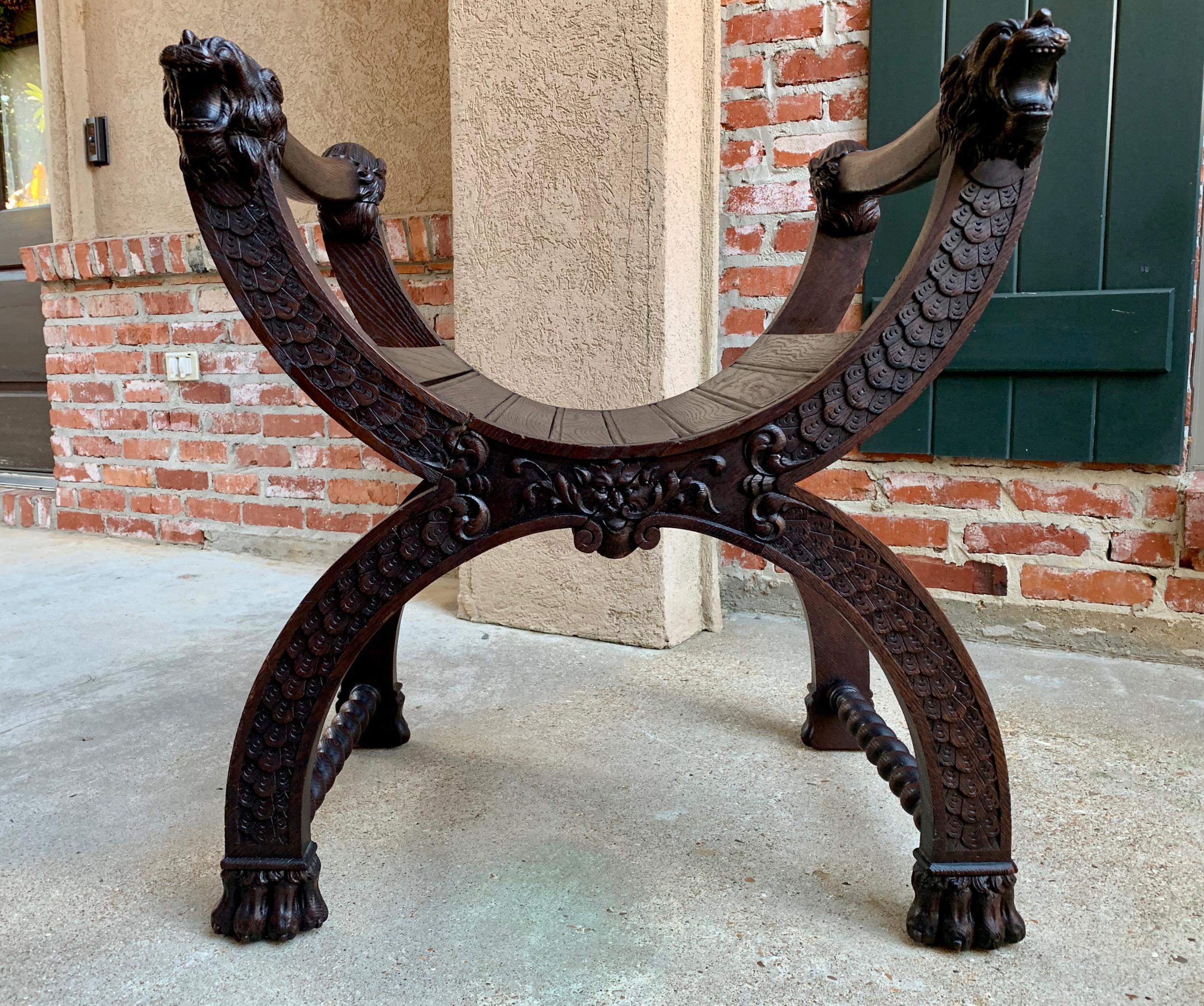 Antique French carved oak curule bench chair renaissance dagobert barley twist

~Direct from France~
~Lovely antique carved oak curule bench with beautifully detailed hand carvings from top to bottom.~
~Sweeping arms extend to four fabulous