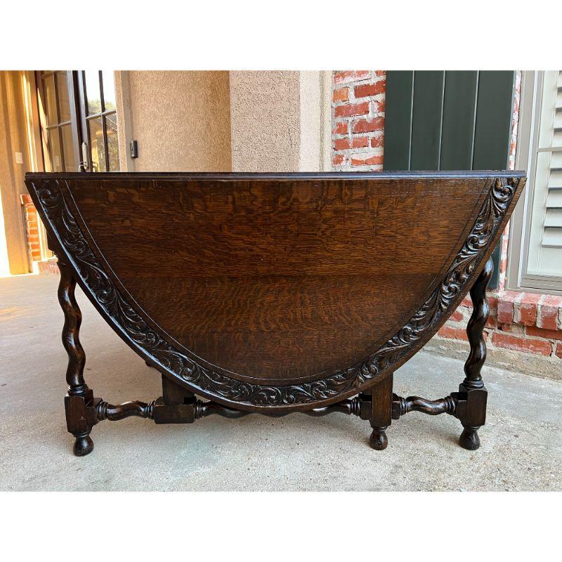 Antique French carved oak dining kitchen table barley twist large drop leaf.

Direct from France, a beautiful and very large antique drop leaf, gate leg table. Wide carved banding around the solid oak, oval table top, with carved designs on both