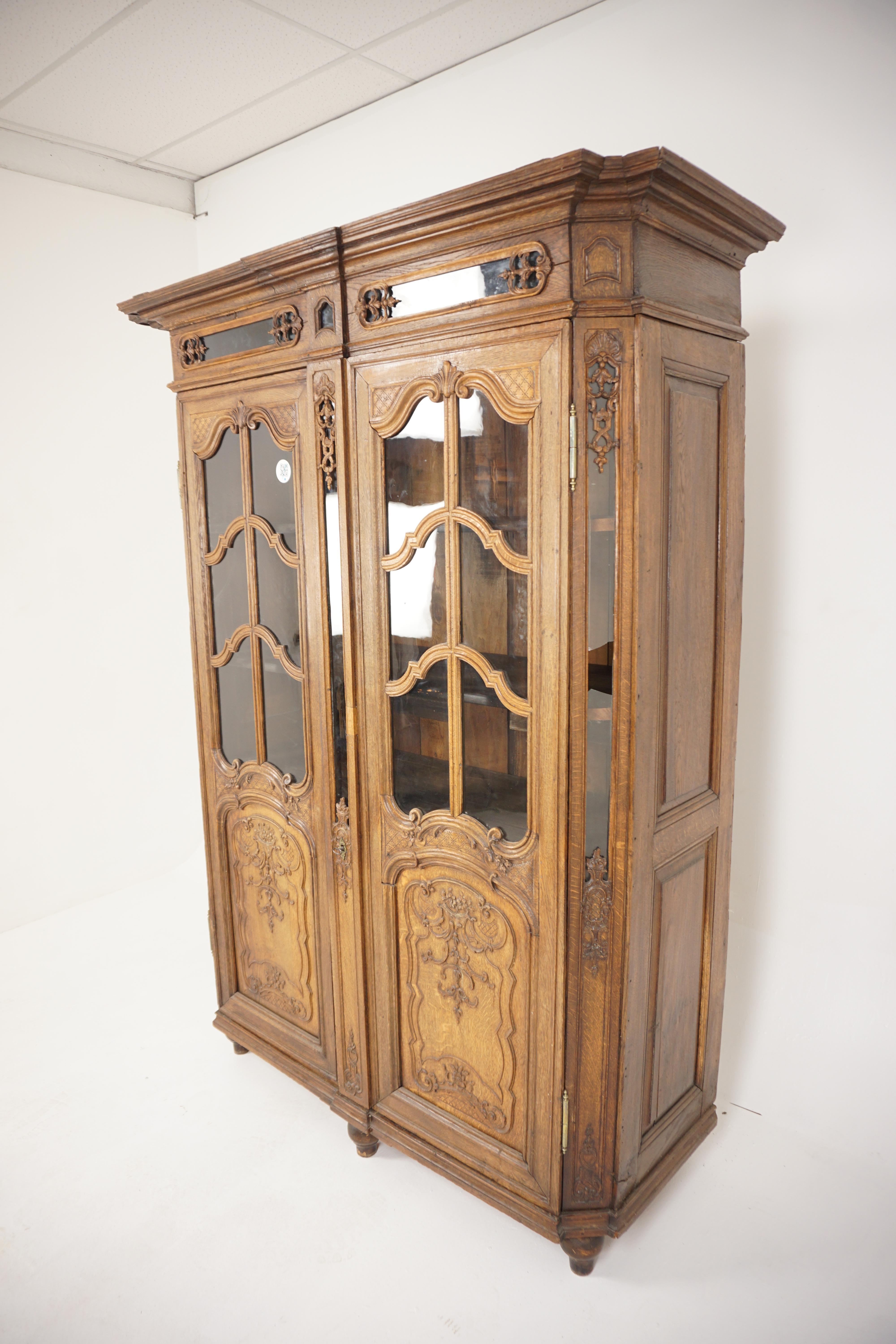 Antique French, carved oak display cabinet bookcase, France, 1880, H109 

France 1880 
Solid Oak 
Original Finish 
Carved cornice with carved frieze below
Pair of original glass doors on top
With carved detailed panels on the bottom of the