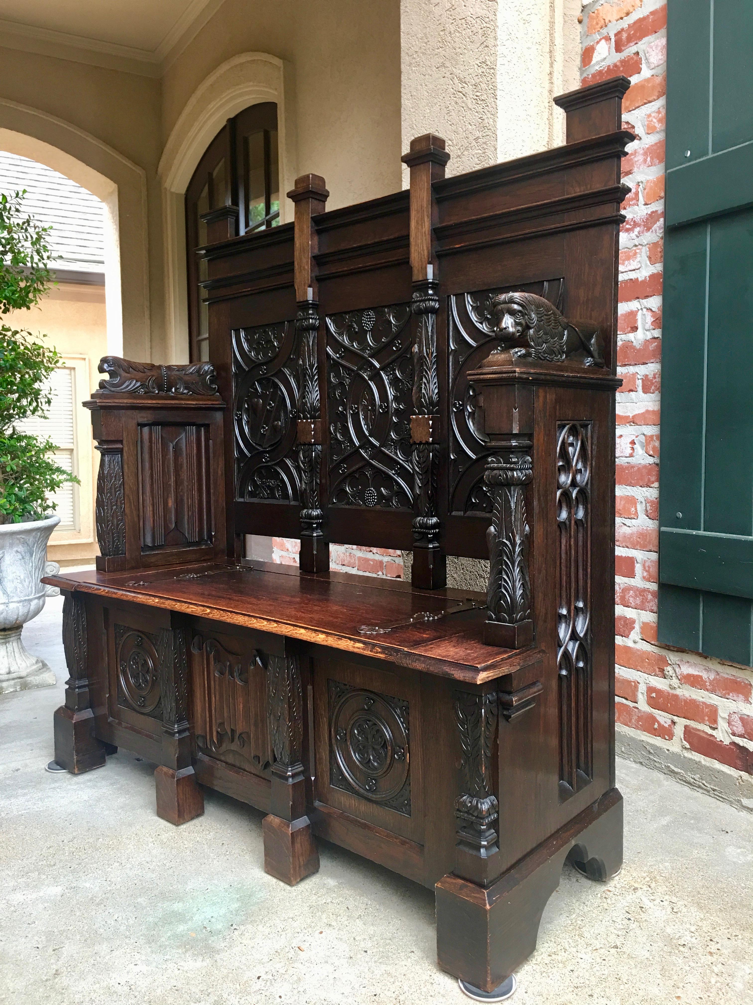 Direct from France, a heavily carved dark oak antique French pew or bench , stunning detail and superb quality!~
~Definitely a statement piece for any room, with a height of almost 5 ft. and carved panels that were surely commissioned to tell a