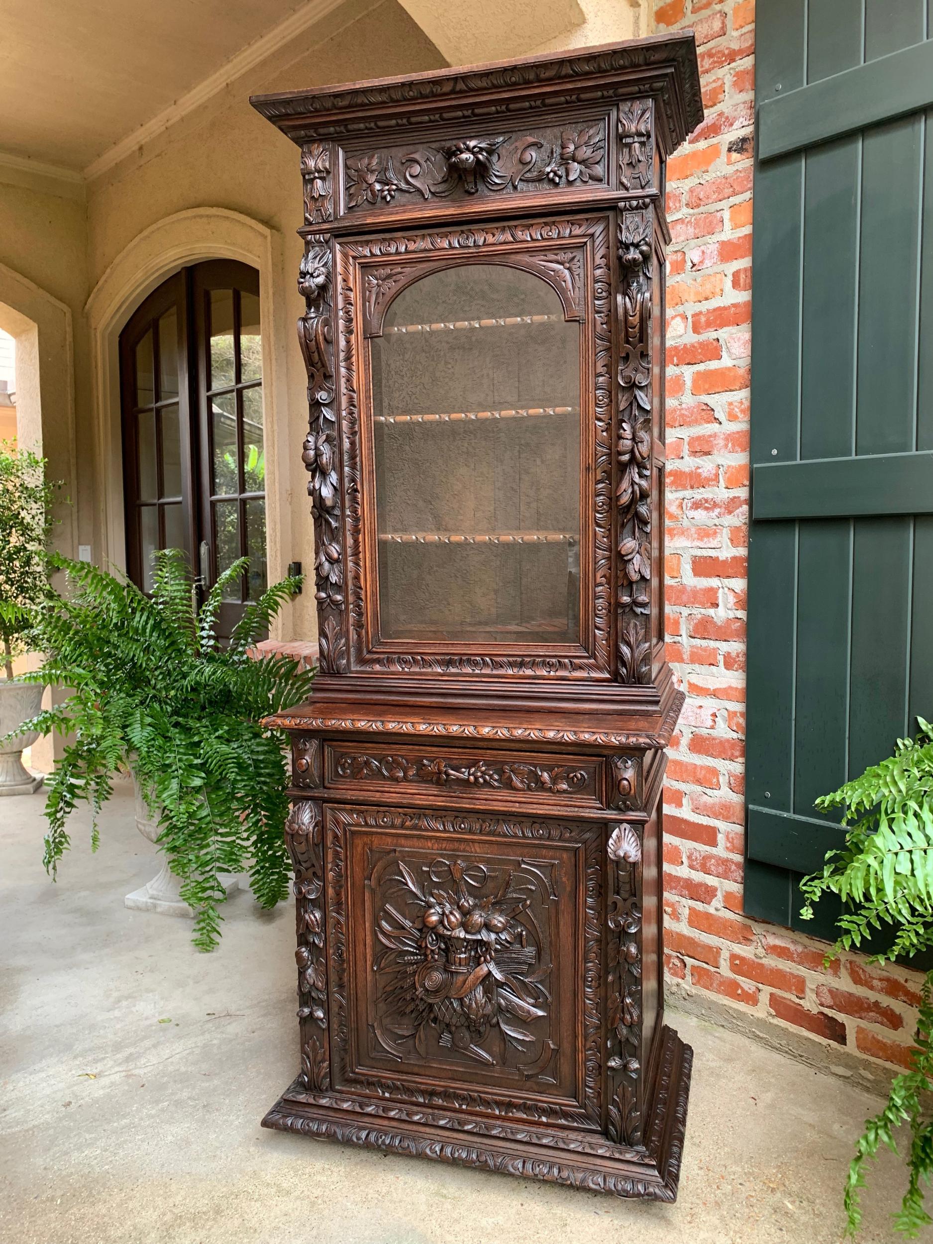 Antique French carved oak hunt cabinet bookcase Black Forest Renaissance display

~Direct from France~
~Exceptional hand carved details on this 19th century French bookcase, having a versatile tall, yet slender profile~
~High carved upper crown,