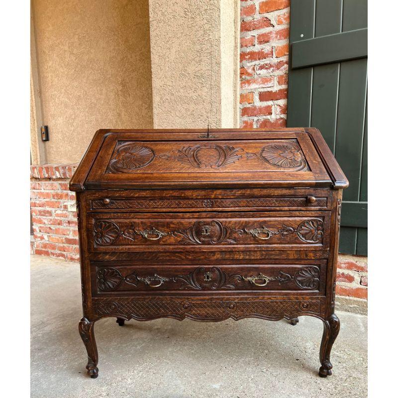 Antique French carved oak secretary desk Bureau drop front Louis XV style.

Direct from France, a lovely antique French carved “drop front” secretary/desk with quintessential French style from top to bottom!
The ‘drop front’ or ‘slant front’ has