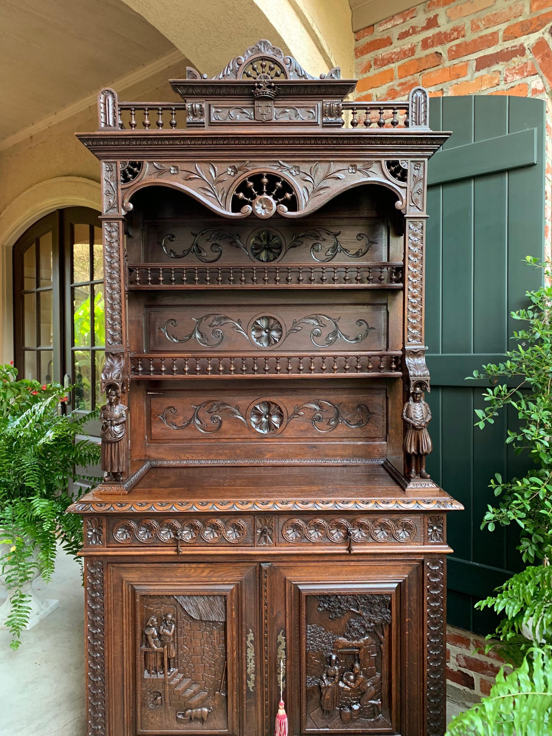 Antique French carved oak sideboard cabinet bookcase Breton Brittany

~Direct from France~
~Ornate 19th century French sideboard/cabinet with stunning Brittany carvings throughout~
~High crown features center arch of Breton “ship’s wheel” spindles