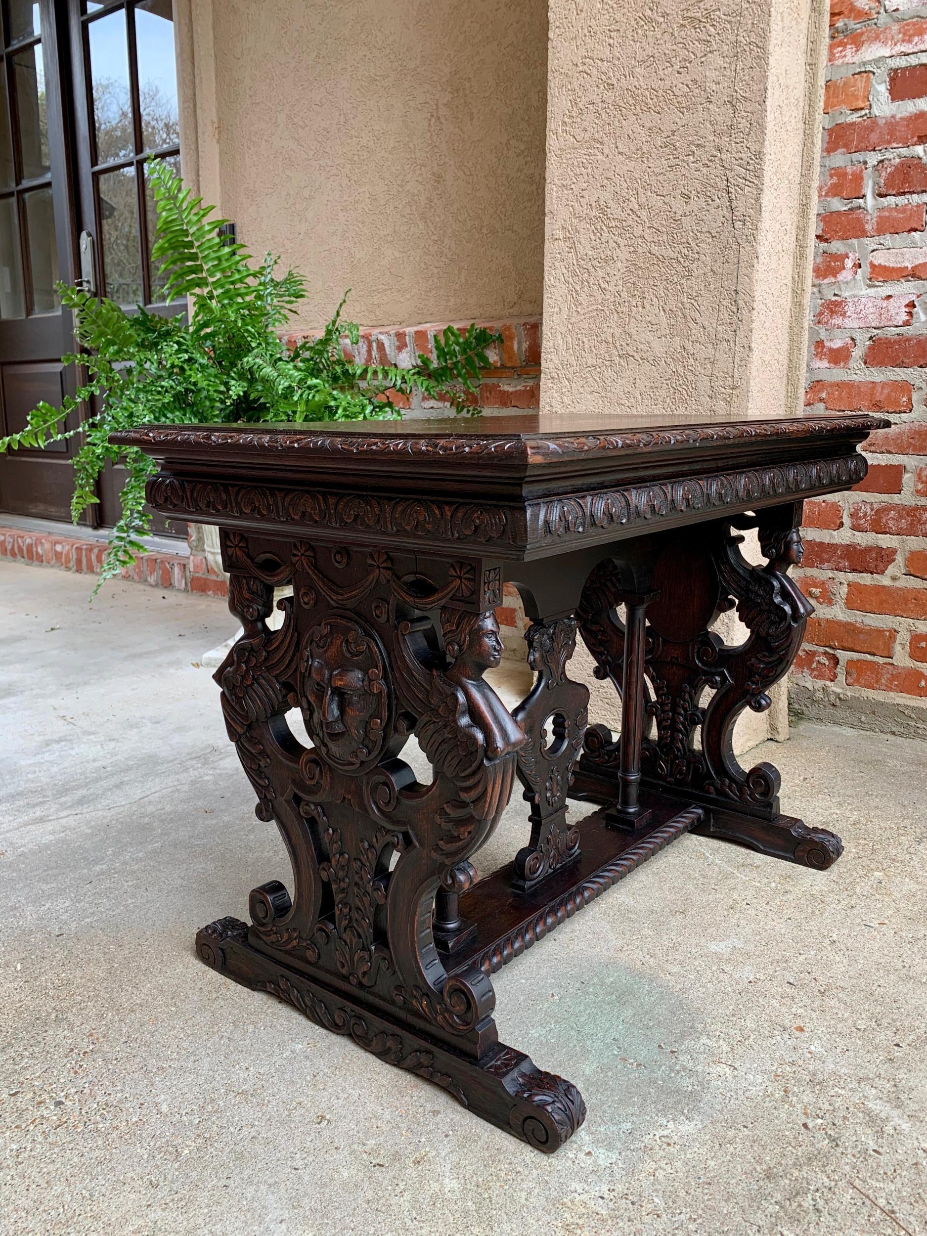 Antique French carved oak sofa side accent table Renaissance Cherub Trestle

~Direct from France~
~Lovely antique French side table, generously carved on all sides~
~Carved beveled edge top above the layered moulding and carved frieze~
~Wide