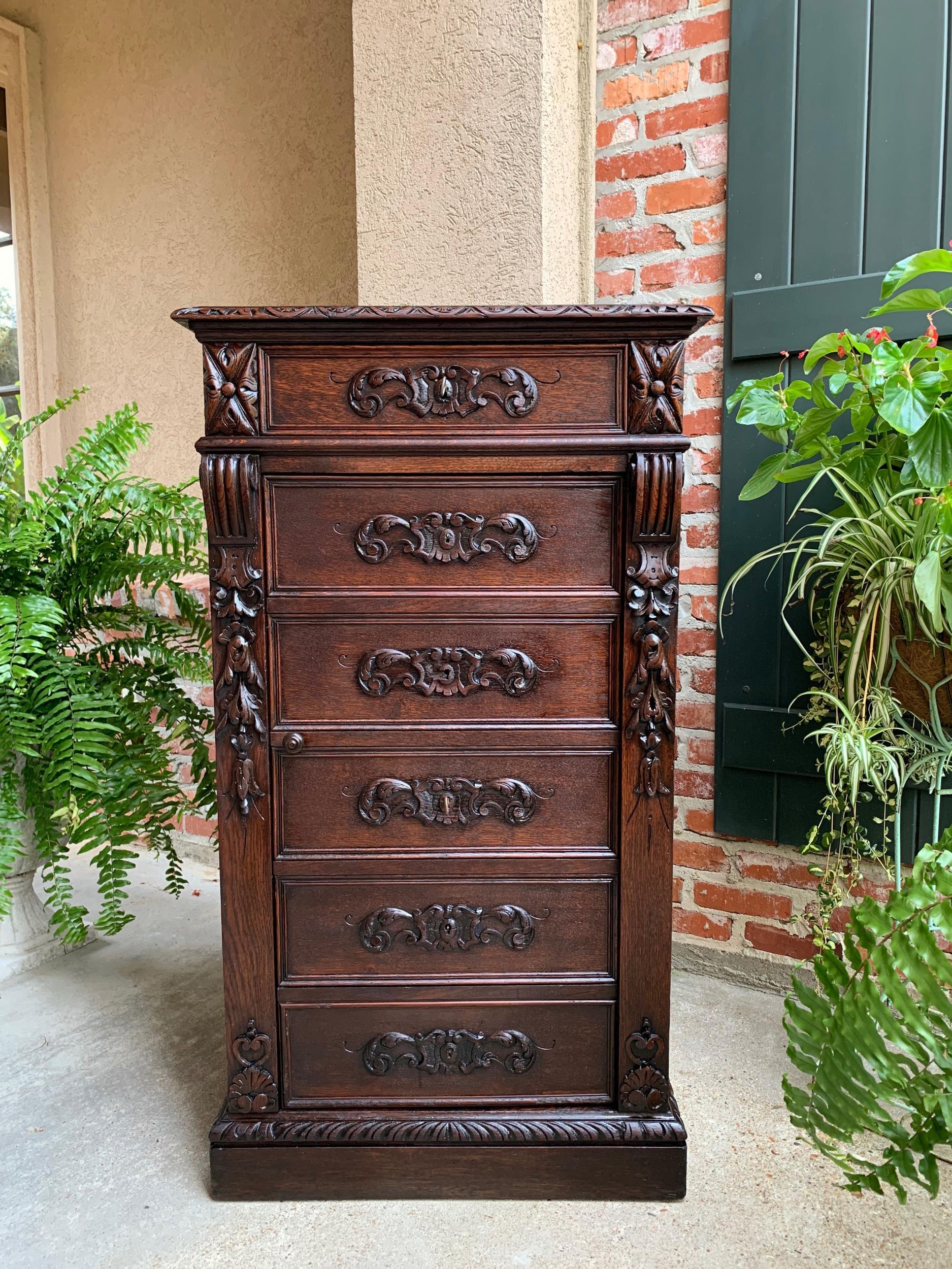 Antique French carved oak tall cabinet faux chest of drawers Louis XIV style.

~Direct from France~
~Highly carved 19th century French cabinet/chest in a tall, yet slender size, perfect for so many uses in today’s home.~
~Upper beveled, carved edge