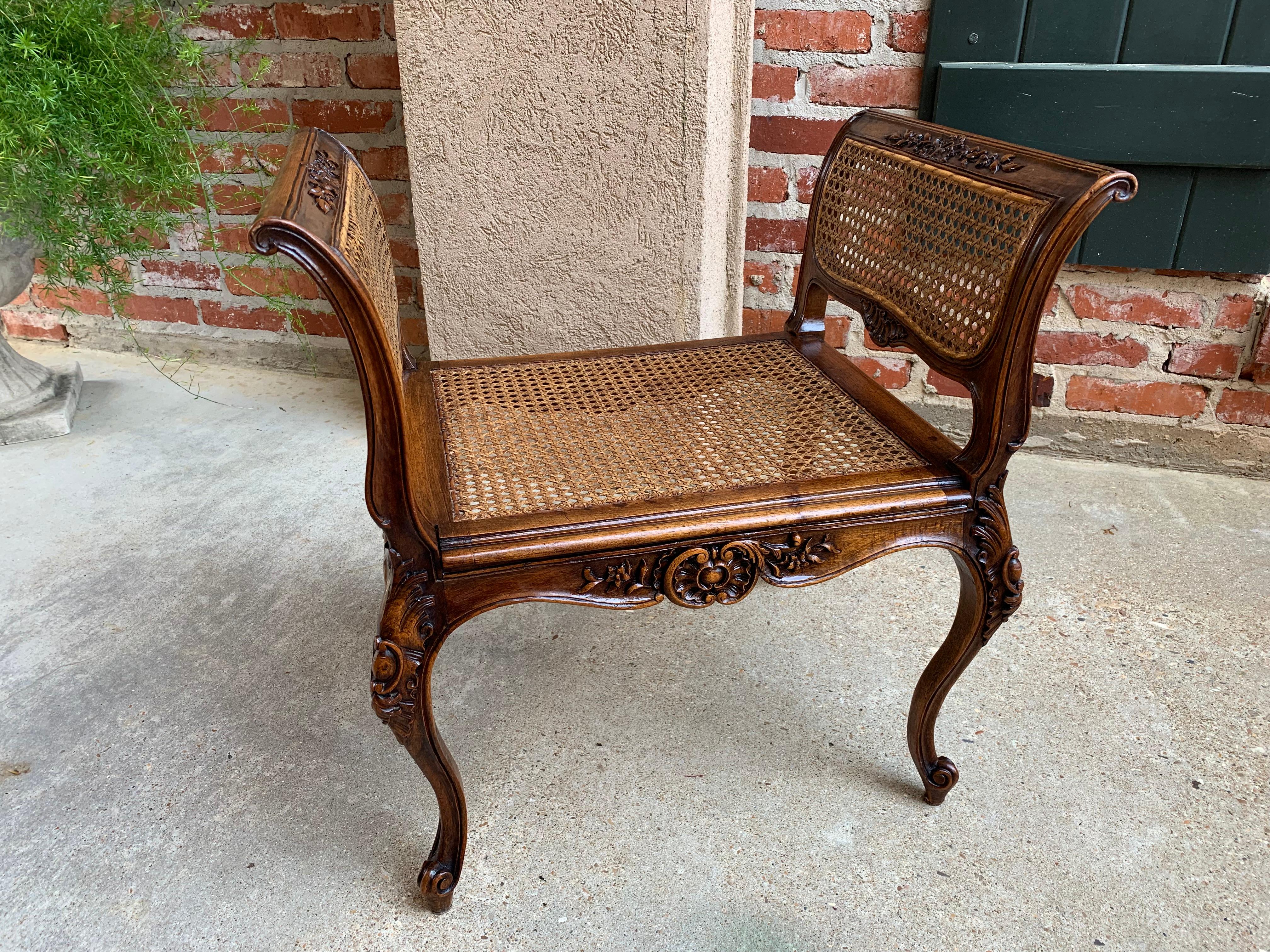 Direct from France, a beautiful antique French bench seat with lovely carvings throughout and original cane seat and sides!~
~The profile immediately catches your eye with it’s scrolled arms and oh-so-French long cabriole legs~
~Abundant carvings