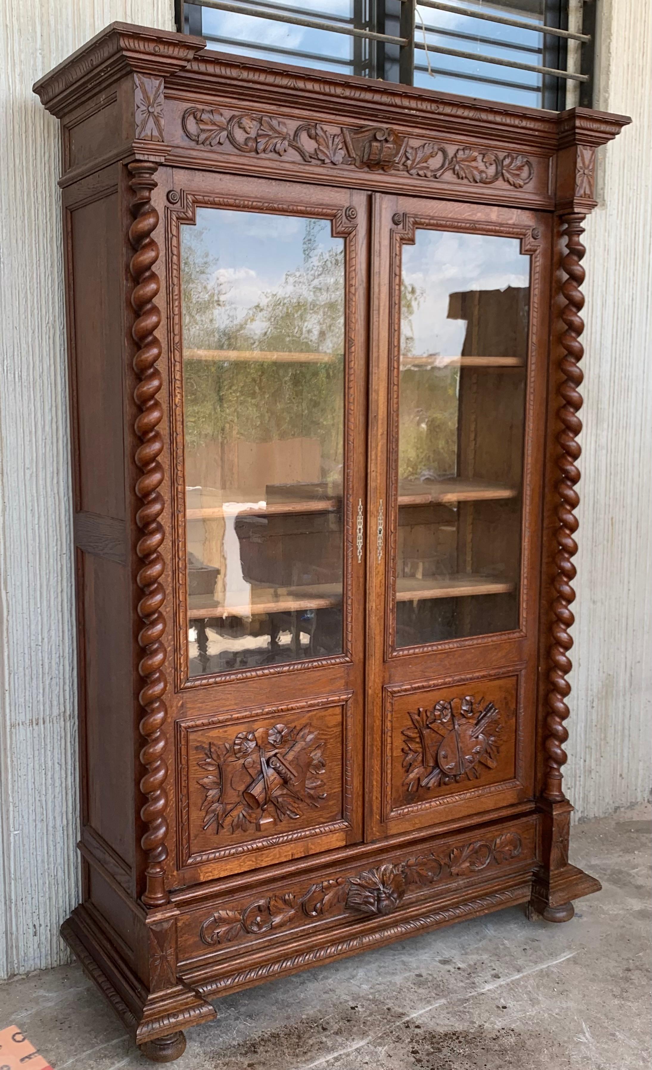 Antique French carved oak vitrine cabinet bookcase barley twist renaissance from France. A gorgeous antique French bookcase cabinet, unusually SLENDER profile, yet very tall and majestic (almost 8. ft.) and covered with beautiful hand carvings! High