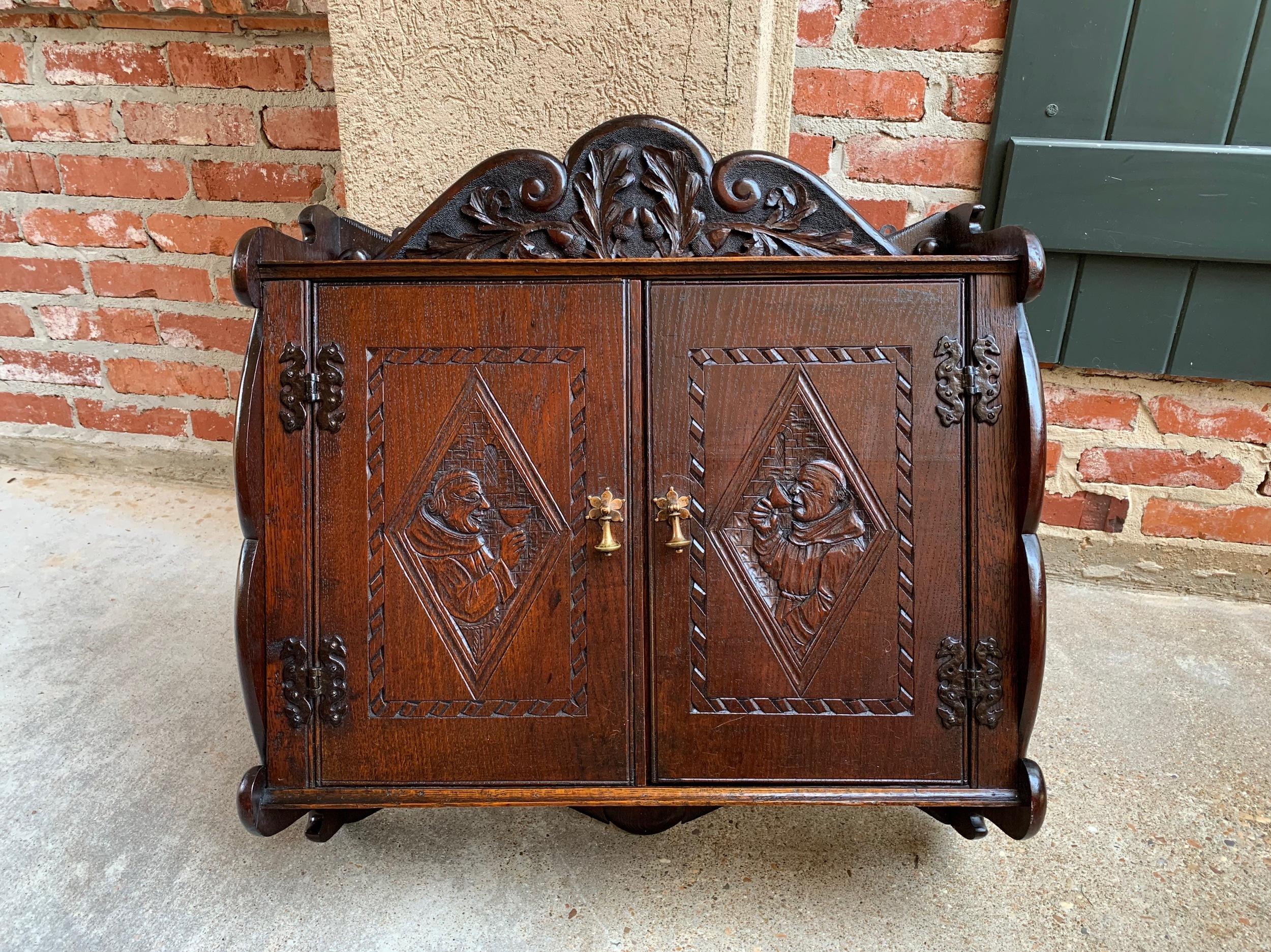 ~Direct from France~
~A fabulous antique French dark oak wall cabinet, loaded with hand carved craftsmanship, and a versatile size for so many different places in your home!~
~Tall, thick, hand carved serpentine crown features foliage and acorns;