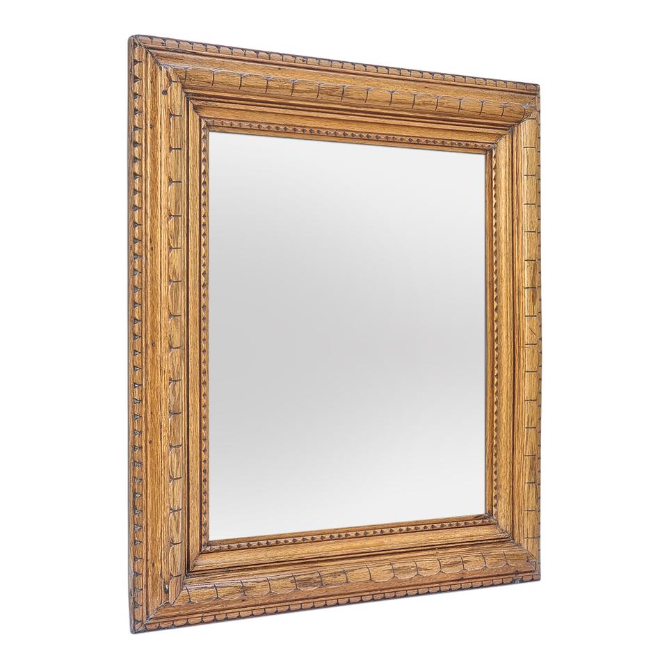 Antique French wall mirror in carved light oak wood decorated in the Breton folk art style (French region). Antique frame measures width 11 cm / 4.33 in. Modern glass mirror. Wood back.