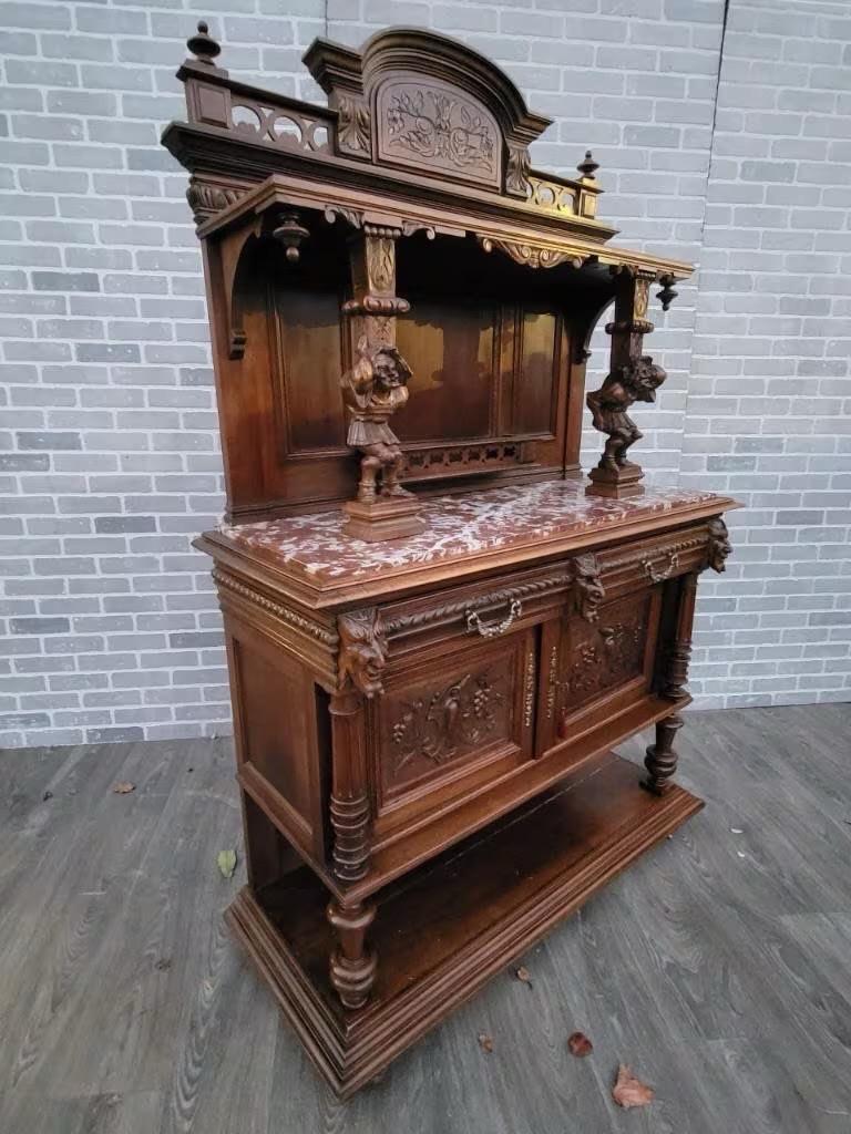 Antique French Carved Ornate Walnut Figural Server Buffet Cabinet 

Stunning Antique Imported from France Hand Carved Ornate Walnut Chateau Marble Top Buffet/Server. A Truly Gorgeous High Quality commission cabinet with full figure jesters, lion