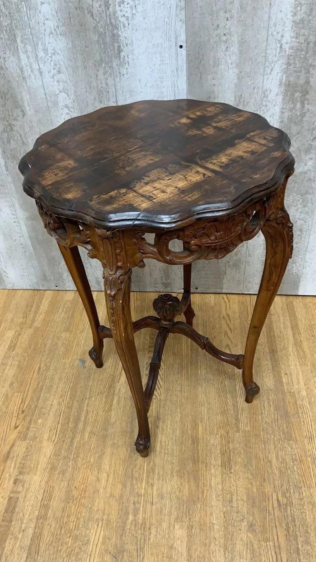 Antique French Carved Side Table

This ornate French side table has a beautiful natural wood grain finish. The apron has been carved with natural flourishes that stretch down the table's legs. Place this side table in your living room or lounge to