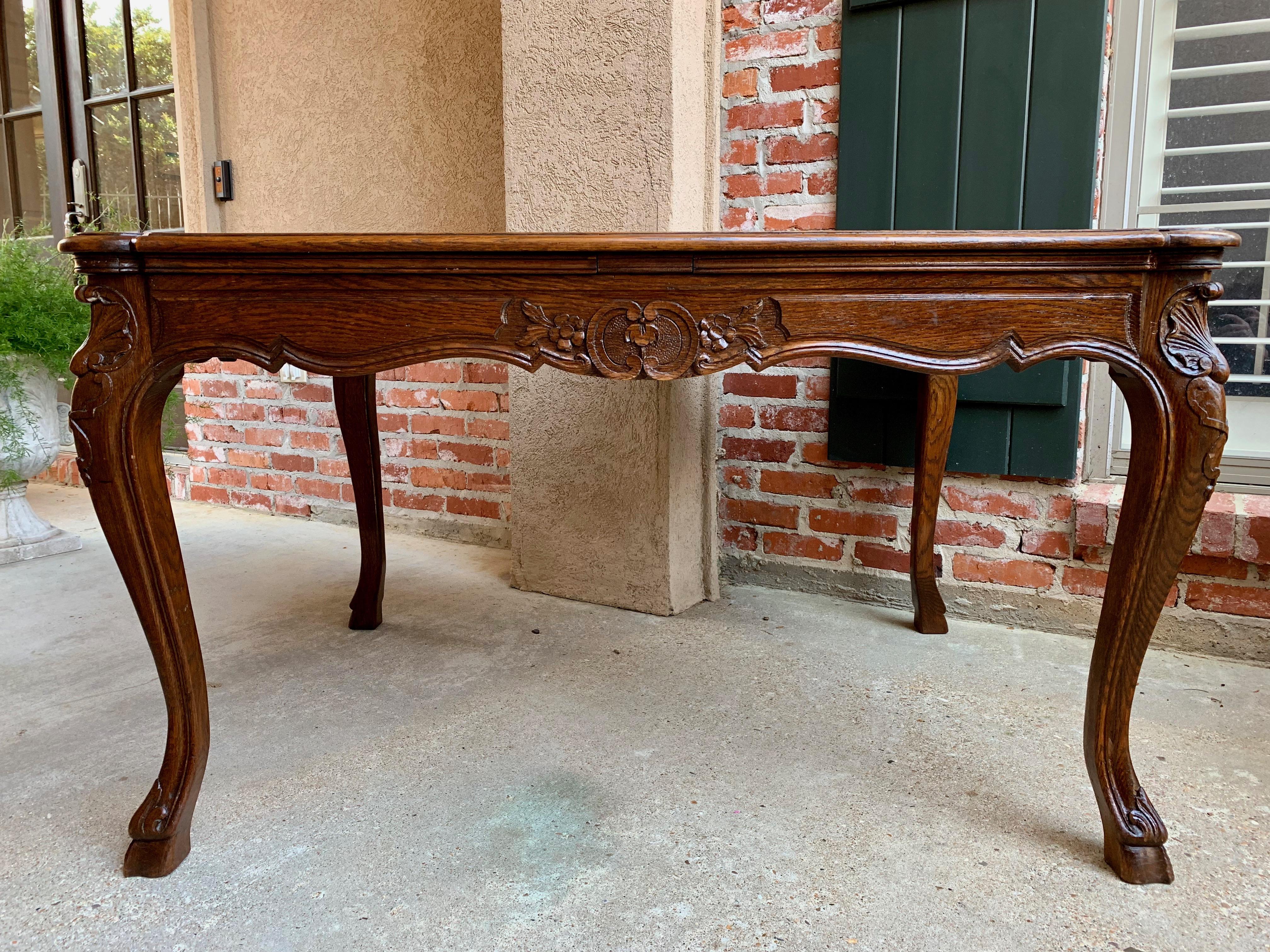 Direct from France, a lovely antique French carved oak dining table with a gorgeous profile!
~Heavily carved cabriole legs and ram’s hoof feet~
~ Parquet beveled edge serpentine oak top~
~Carved apron, elaborately carved on all sides~
~Excellent