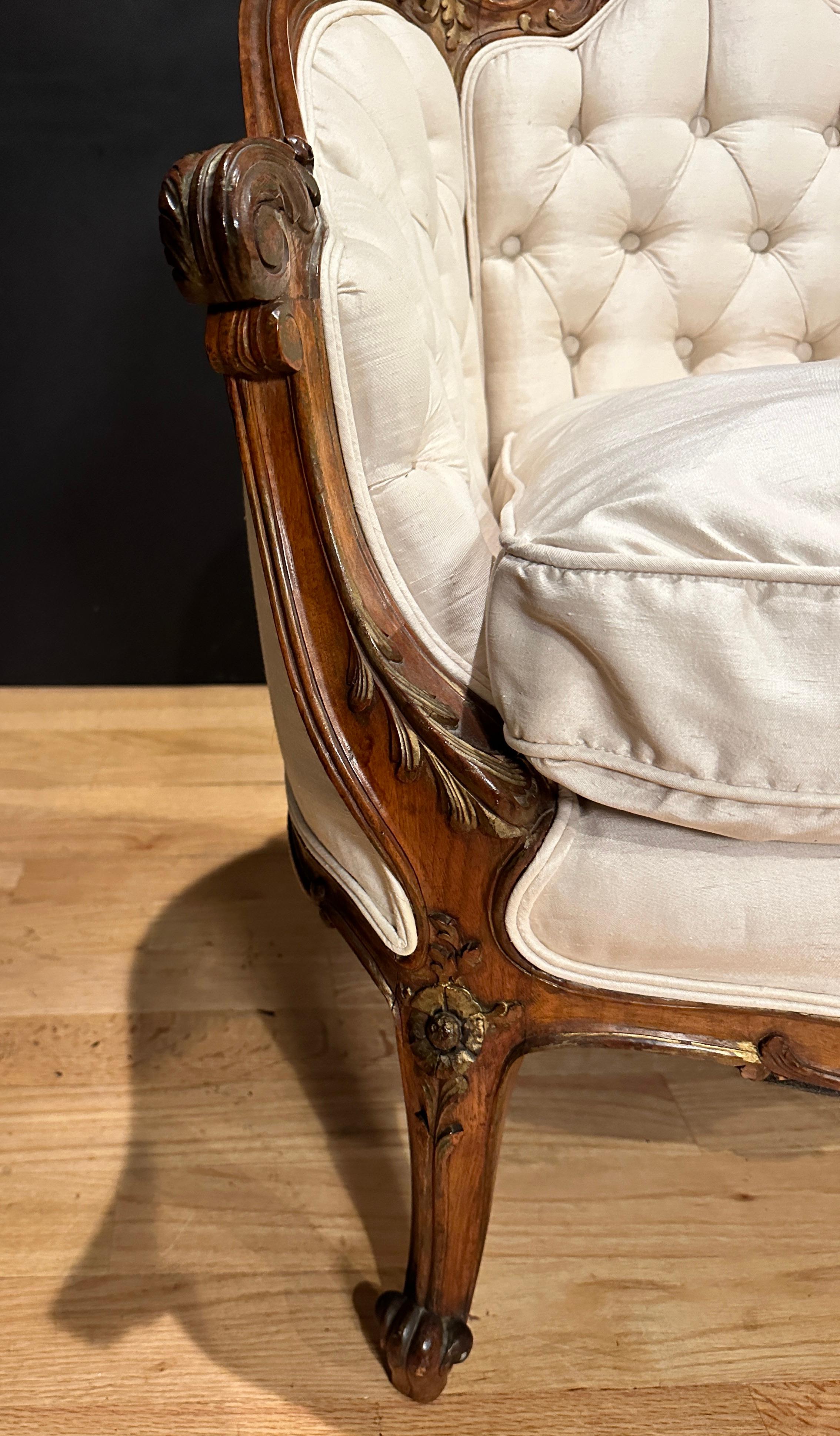 Hand-Carved Antique French Carved Walnut And Parcel Gilt Armchair For Sale