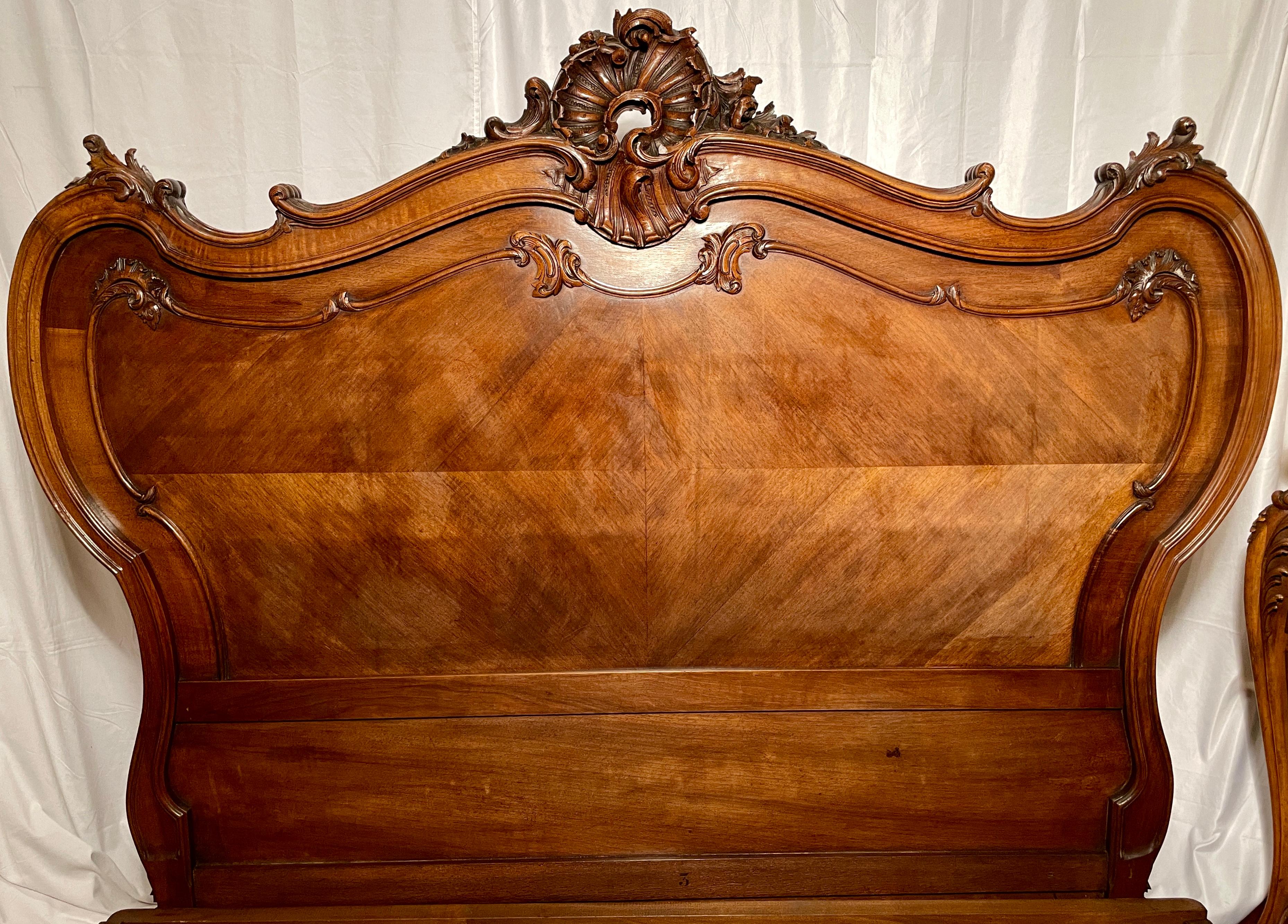 Queen size masterfully carved antique French walnut bed and night table, circa 1875-1895. 

Dimensions: 
Exterior- 62 inches high (headboard) x 68.5 inches wide x 89 inches long 
Interior: 59 inches wide x 80 inches long
Side table- 33 inches