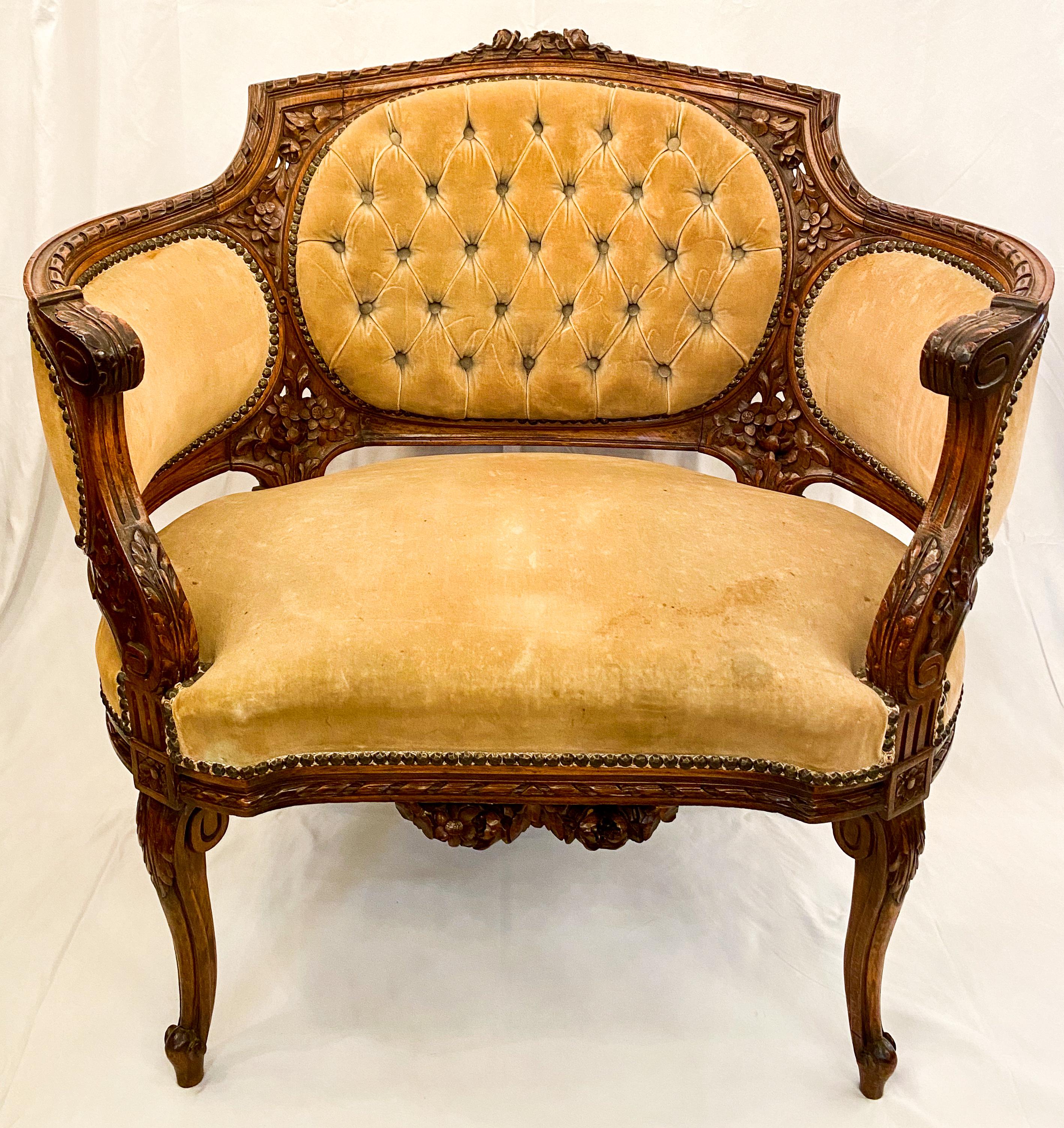 Antique French carved walnut bergère chair circa 1870s with original beautiful yellow ochre velvet upholstery. One tear in upholstery is visible on the back of the chair as shown in the photos. A beautiful, sturdy, hand carved chair in very good