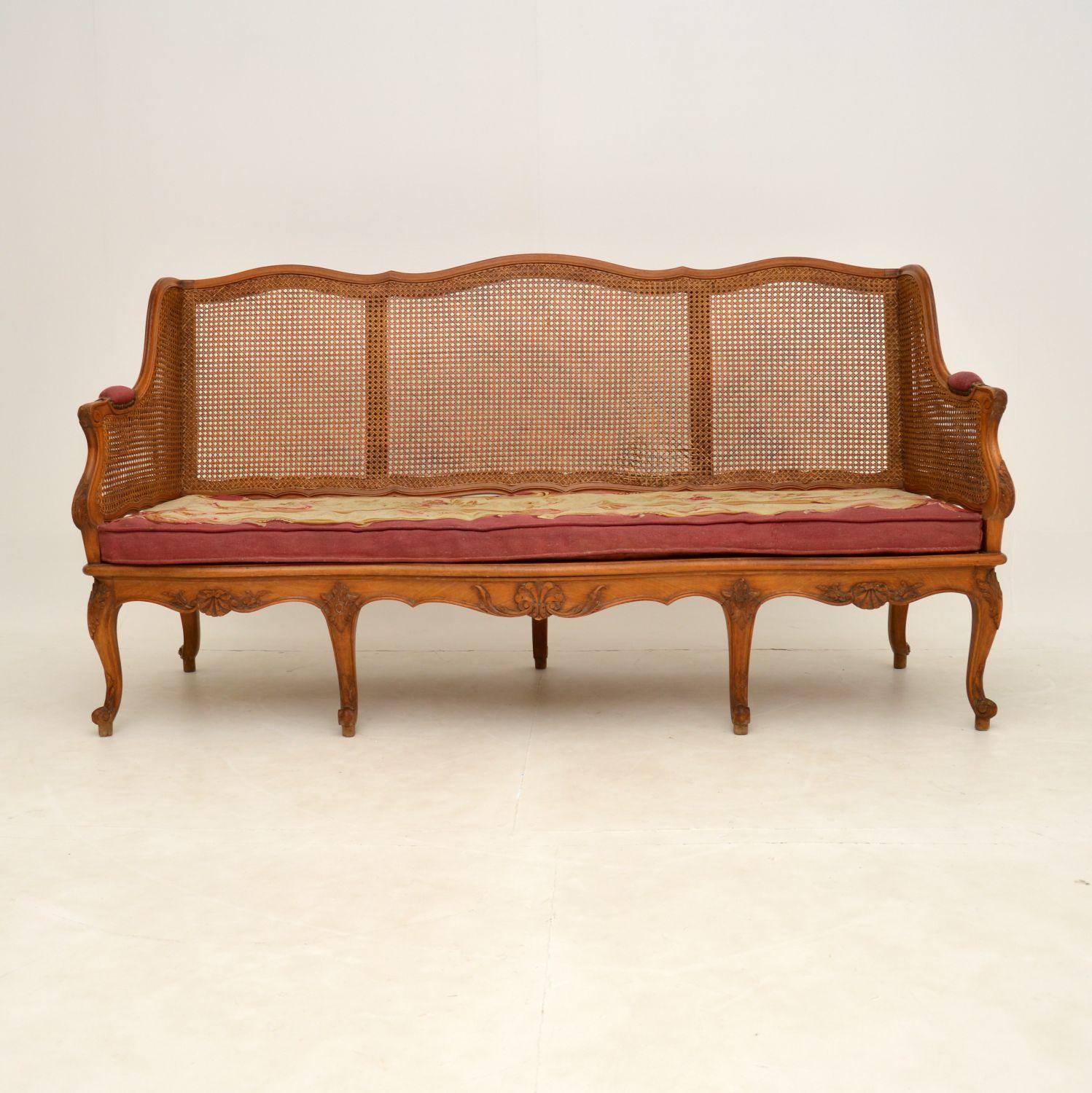 A stunning original French antique carved walnut sofa, with a caned seat and back. I would date this from around the 1860-1880’s period.

It is of wonderful quality, with beautiful carving all over and excellent double caning on the back and sides.