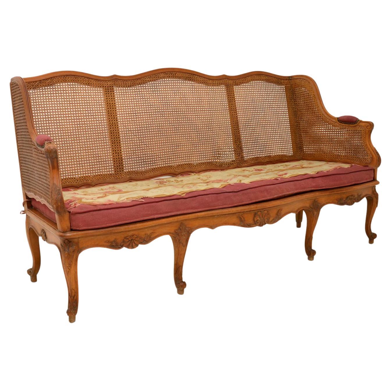 Antique French Carved Walnut Bergere Sofa For Sale