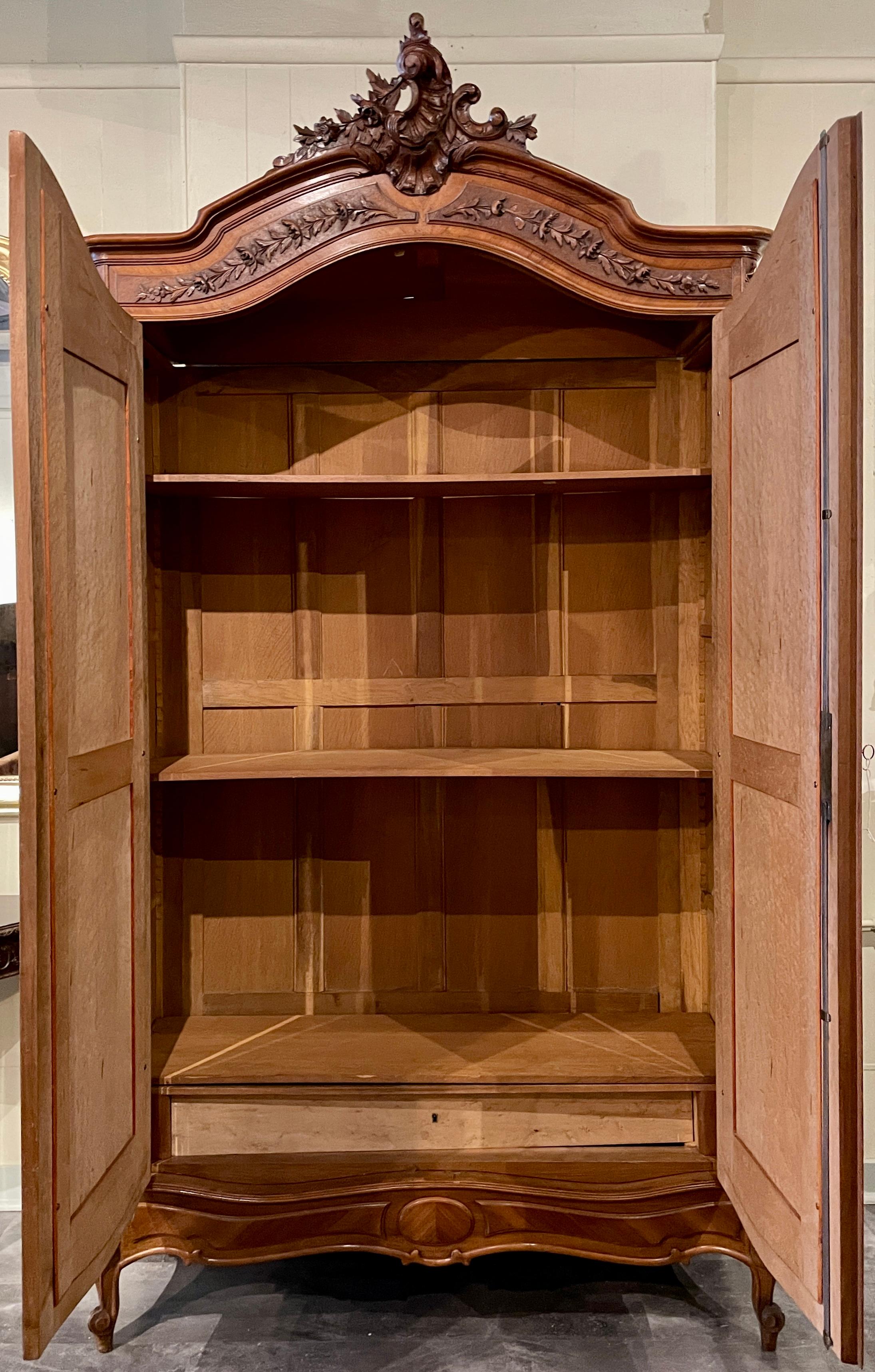 Antique French finely carved walnut double door armoire with beveled mirrors, Circa 1890.