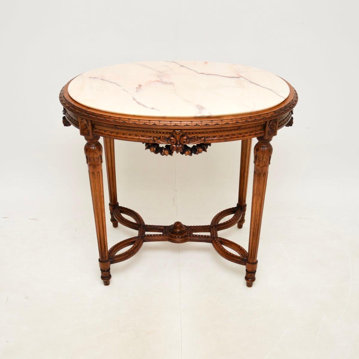 A beautiful antique French carved walnut marble top occasional table, dating from around the 1930’s.

It is of superb quality and is a lovely size, perfect for use as an occasional side table or centre table. There is crisp carving around the edges