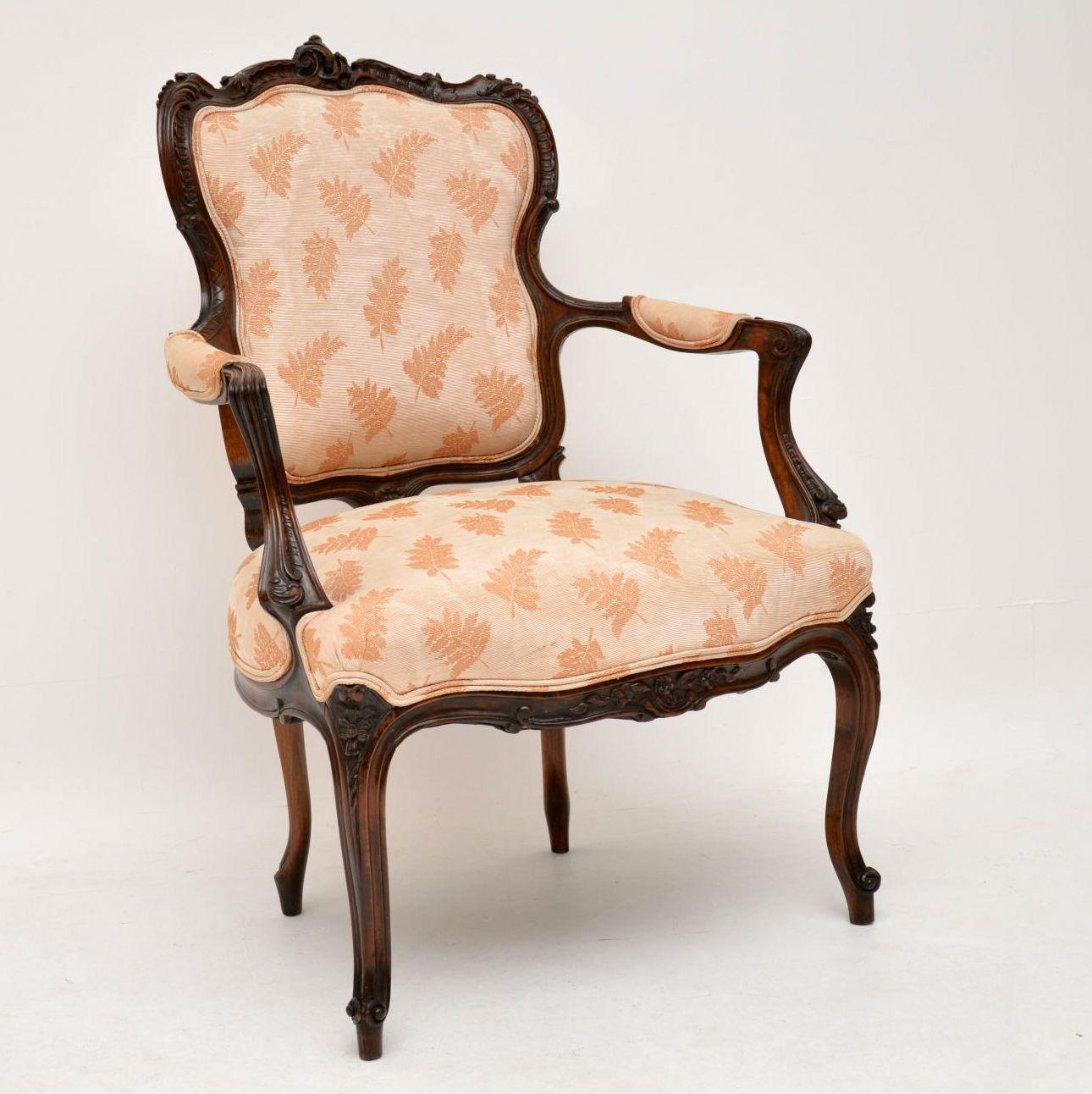 French antique walnut salon armchair in good original condition, dating roughly from the 1880s period. It’s finely carved all-over and the carving is very crisp. This chair is structurally sound & the upholstery is still in good condition. It has a