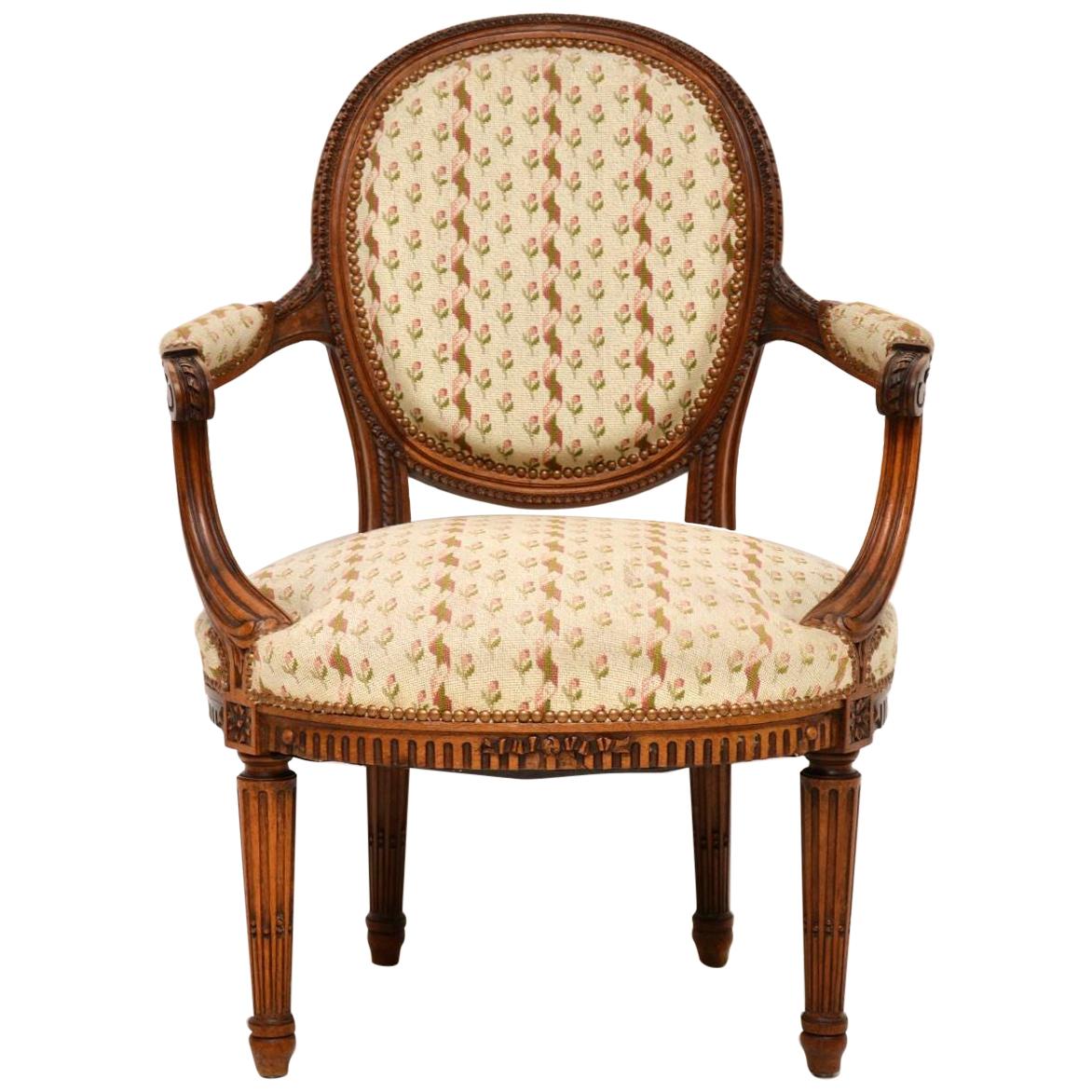 Antique French carved walnut framed salon armchair in good original condition. It’s structurally sound and the upholstery is still okay, although I think the seat springs need a bit of attention. We do normally recover upholstered furniture, but