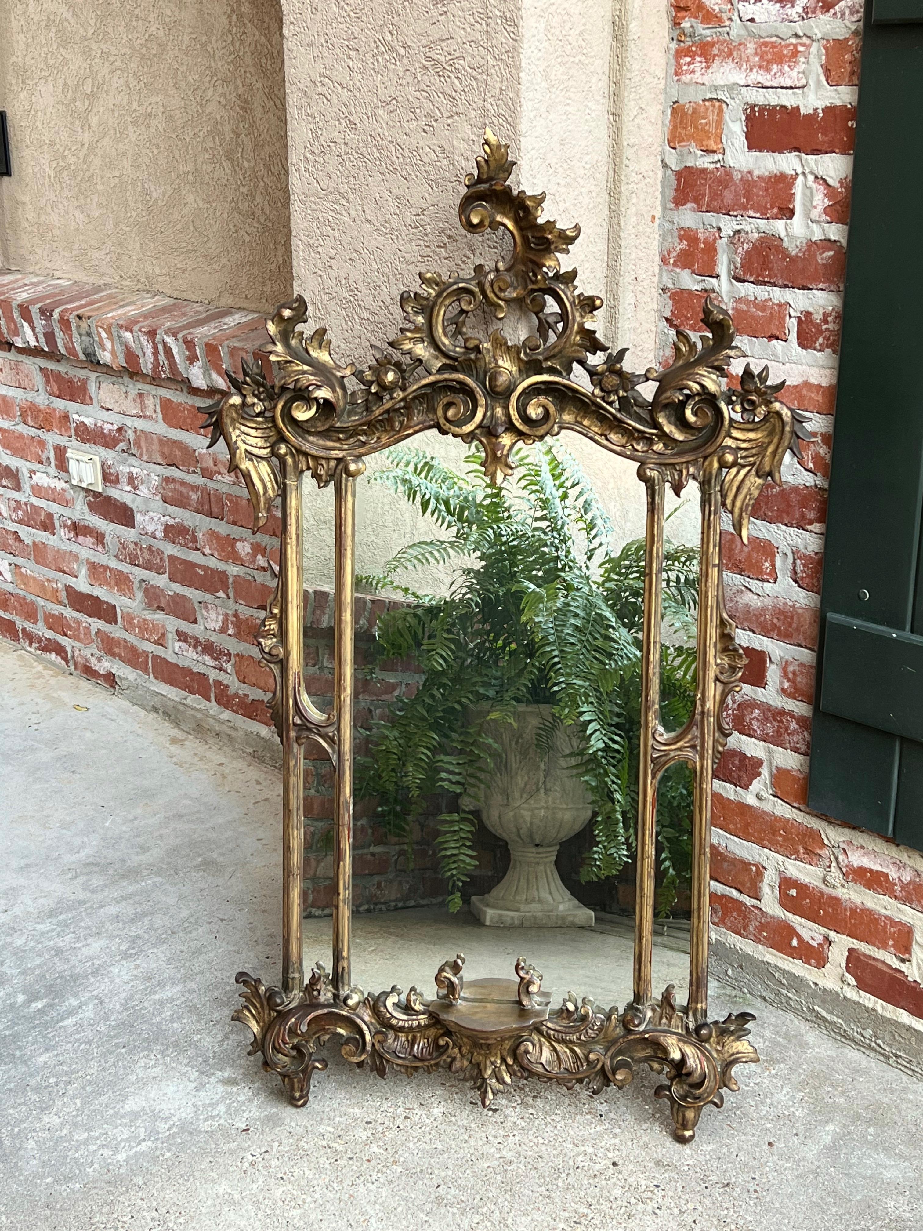 Antique French carved wood gold gilt frame wall mantel mirror Rococo Louis XV

Direct from France, a very ornate antique gold gilt mirror, large in size with spectacular details!
Fabulous large crown, asymmetrical rococo styling, with highly