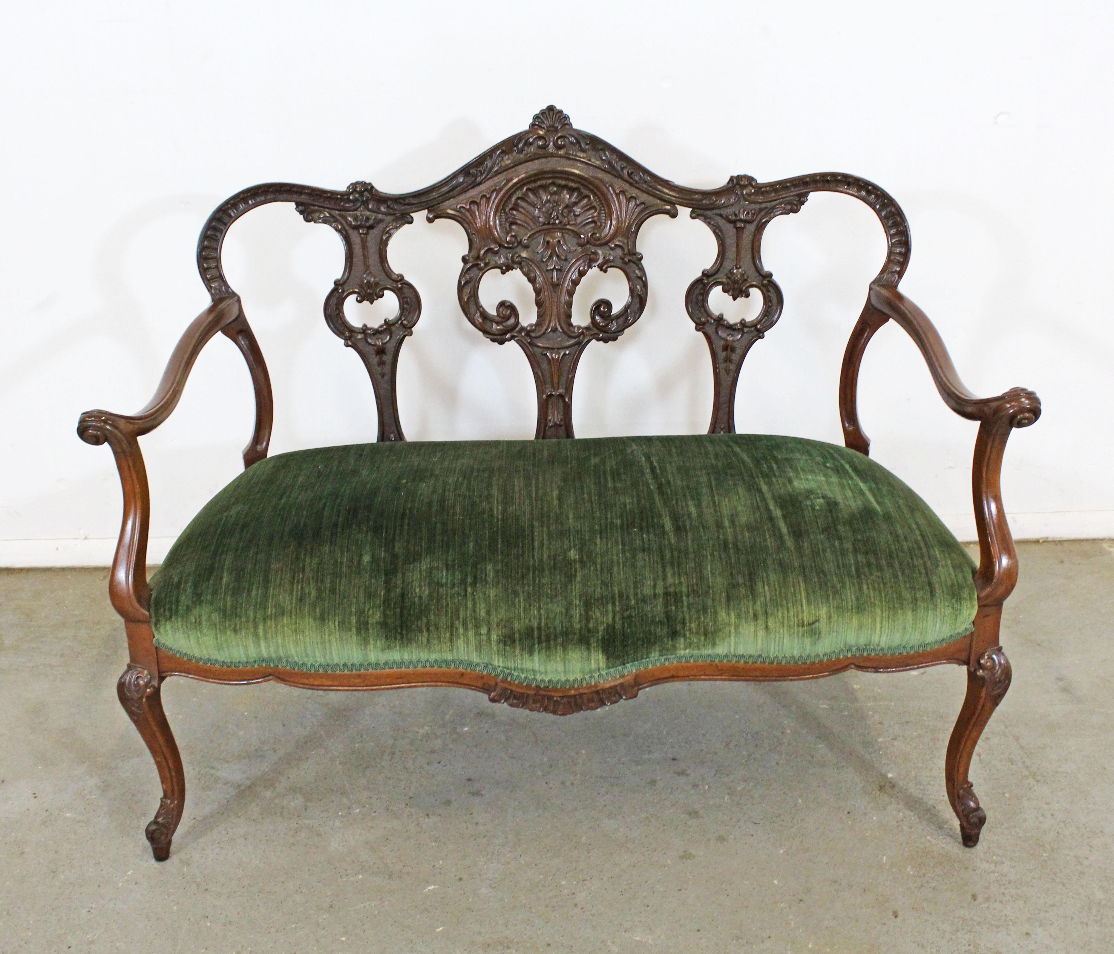 Offered is an antique French or Victorian style settee/bench with a beautifully carved wooden frame and upholstered seat, circa late 1800s. In decent condition for its age with normal age wear. Some fading/wear on upholstery and some surface